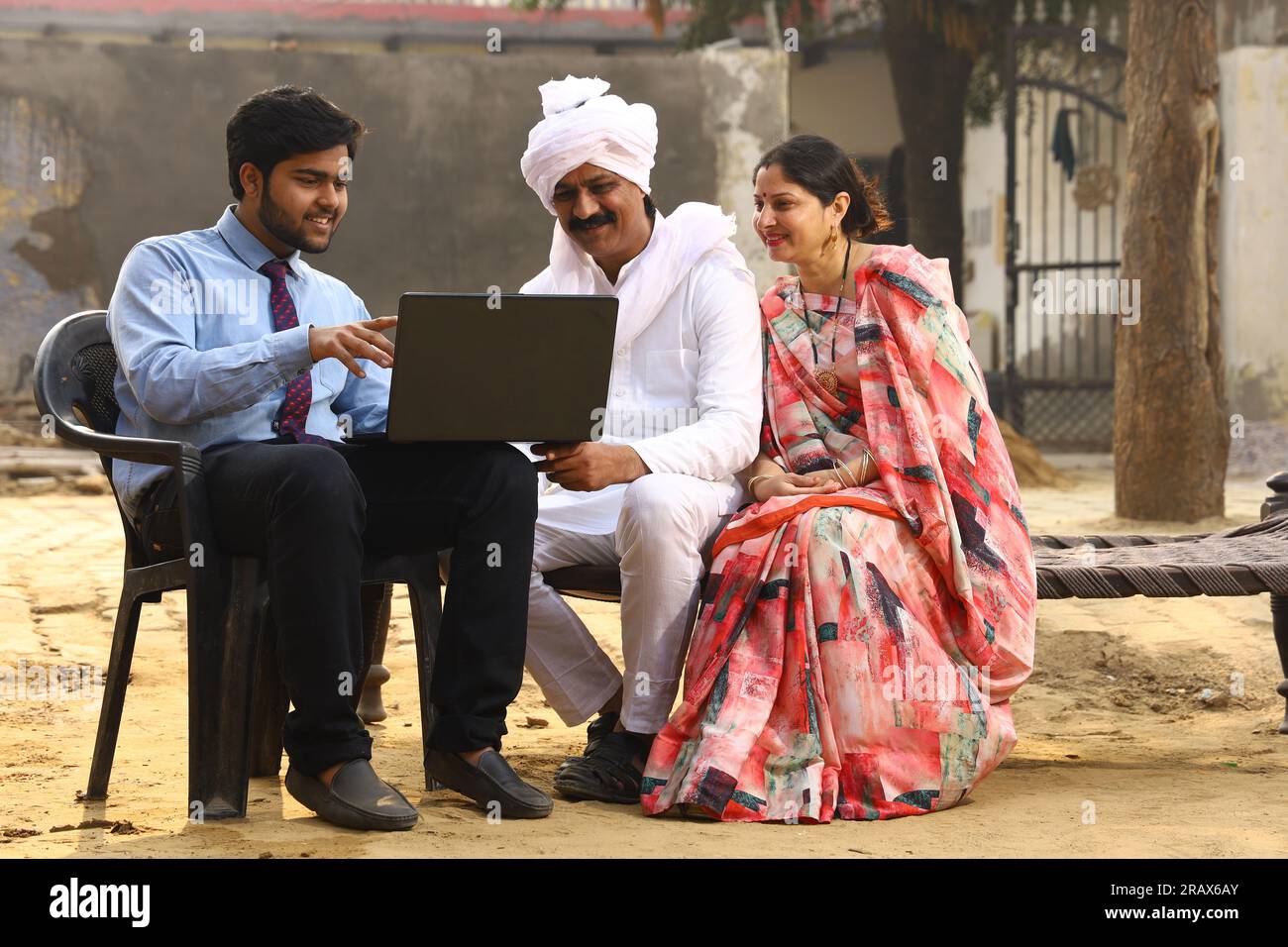 Happy rural Indian family in village Aspirational family sitting with a