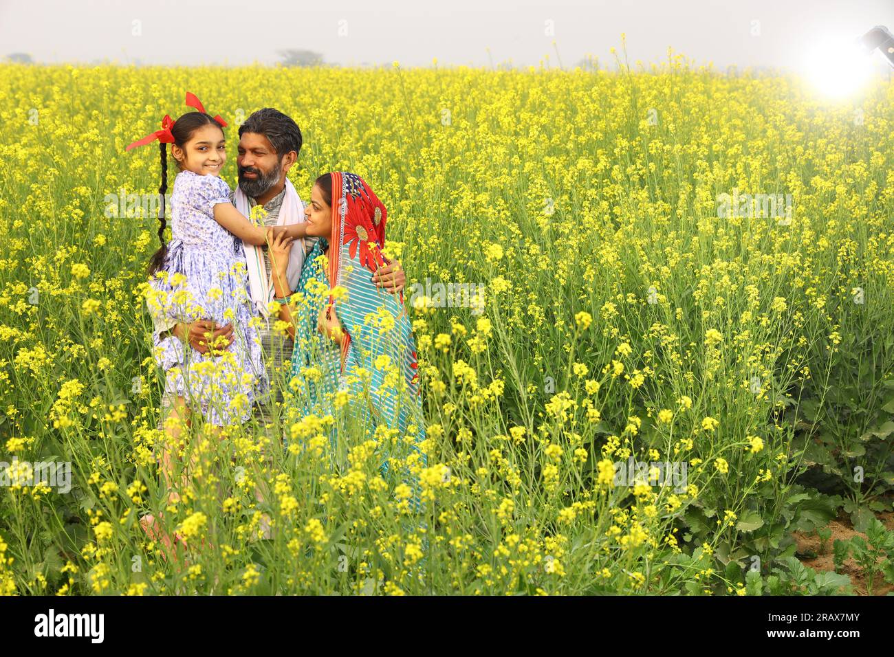 Farmer with daughter standing in mustard field hi-res stock photography ...