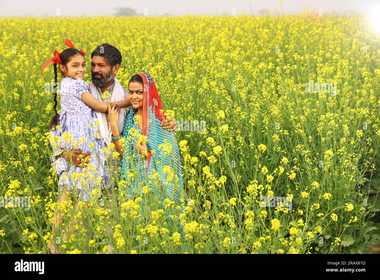 Farmer with daughter standing in mustard field hi-res stock photography ...