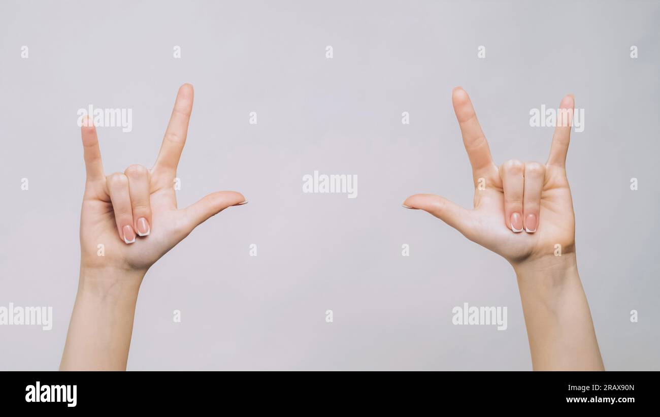 Rock sign punk gesture woman fingers showing horns Stock Photo