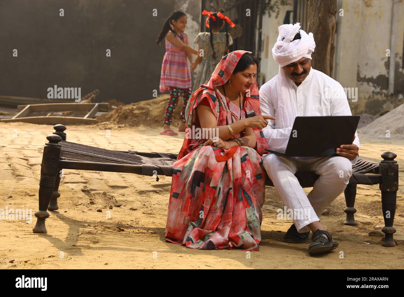 Happy Indian Rural family in village. Rural couple sitting together ...