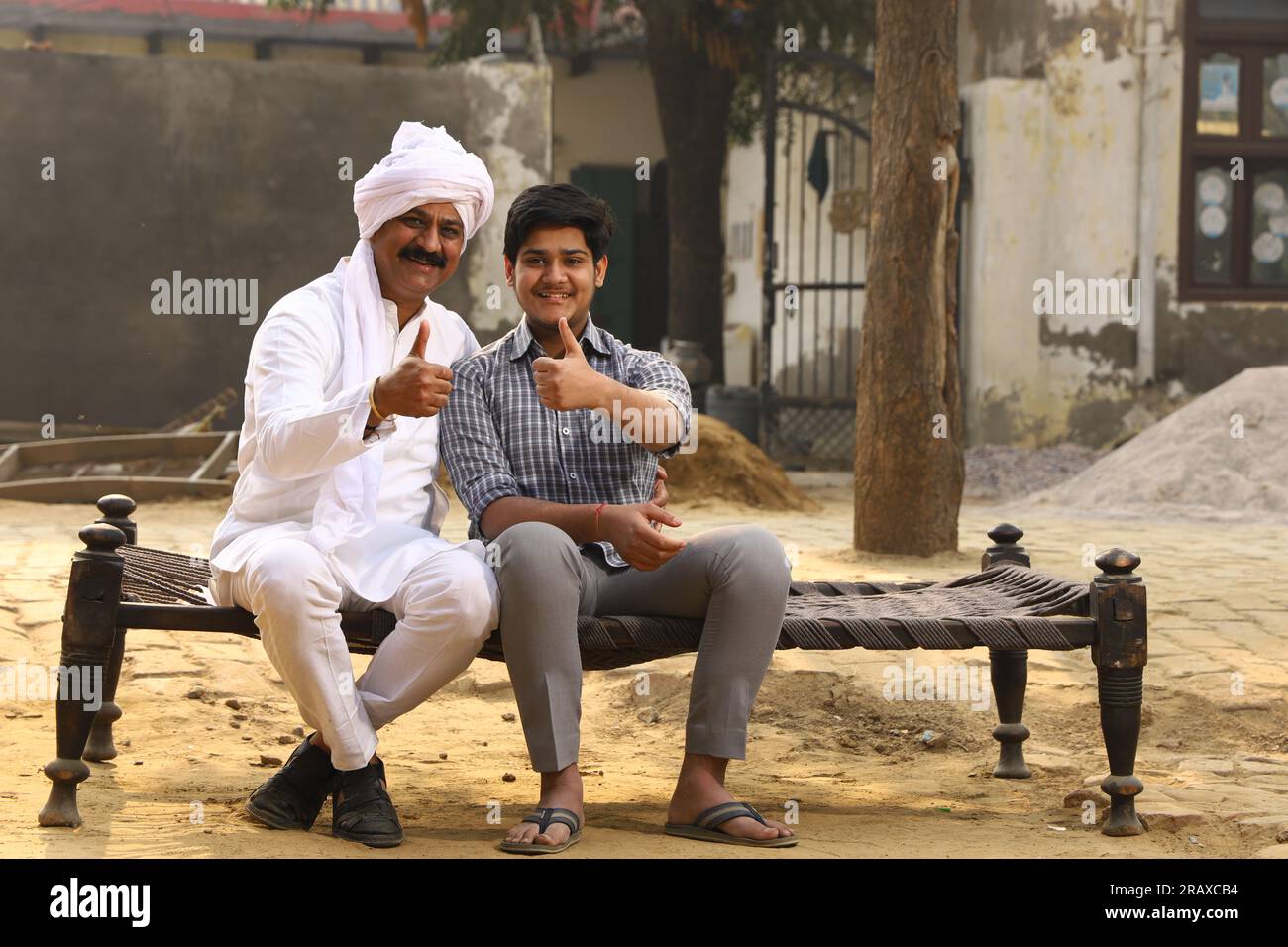 Happy rural Indian family in village Aspirational family sitting with a