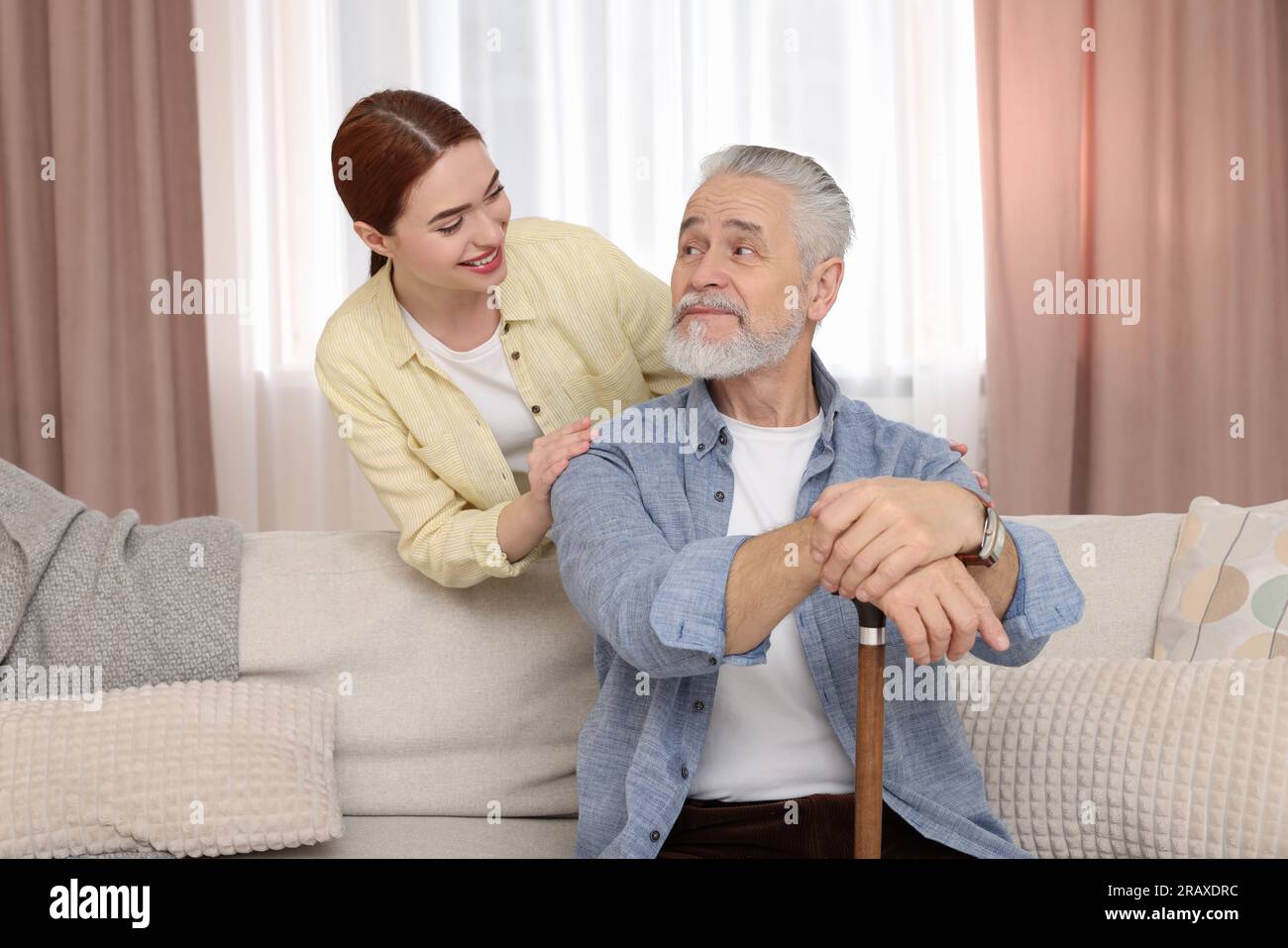 Caregiver and senior man with walking cane at home Stock Photo - Alamy