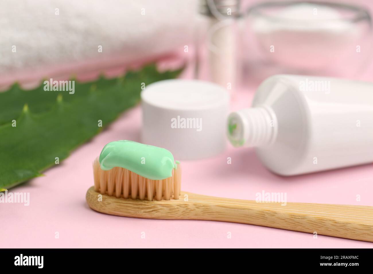 Toothbrush with aloe toothpaste on pink background, closeup Stock Photo