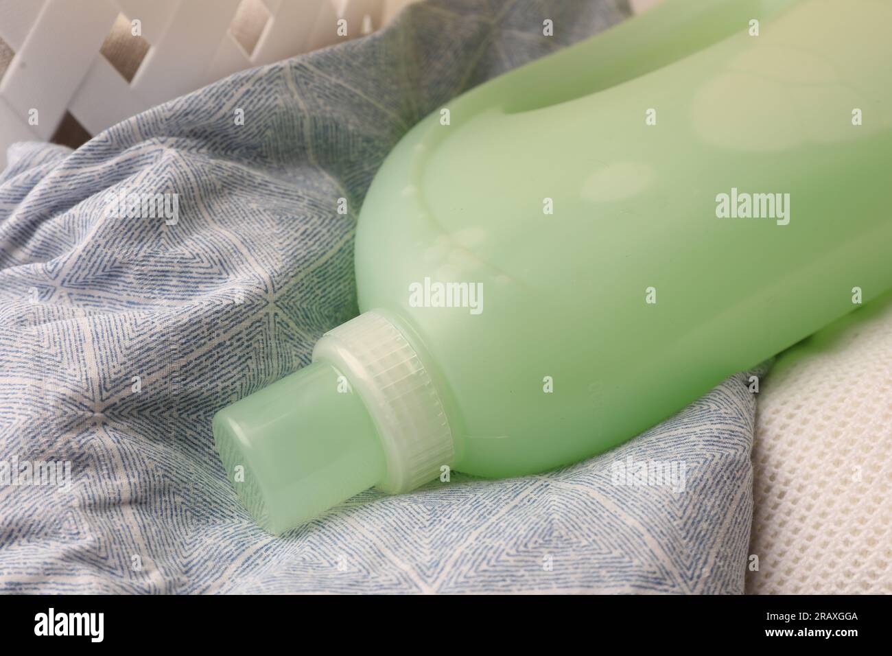 Bottle of fabric softener on clothes, closeup Stock Photo Alamy