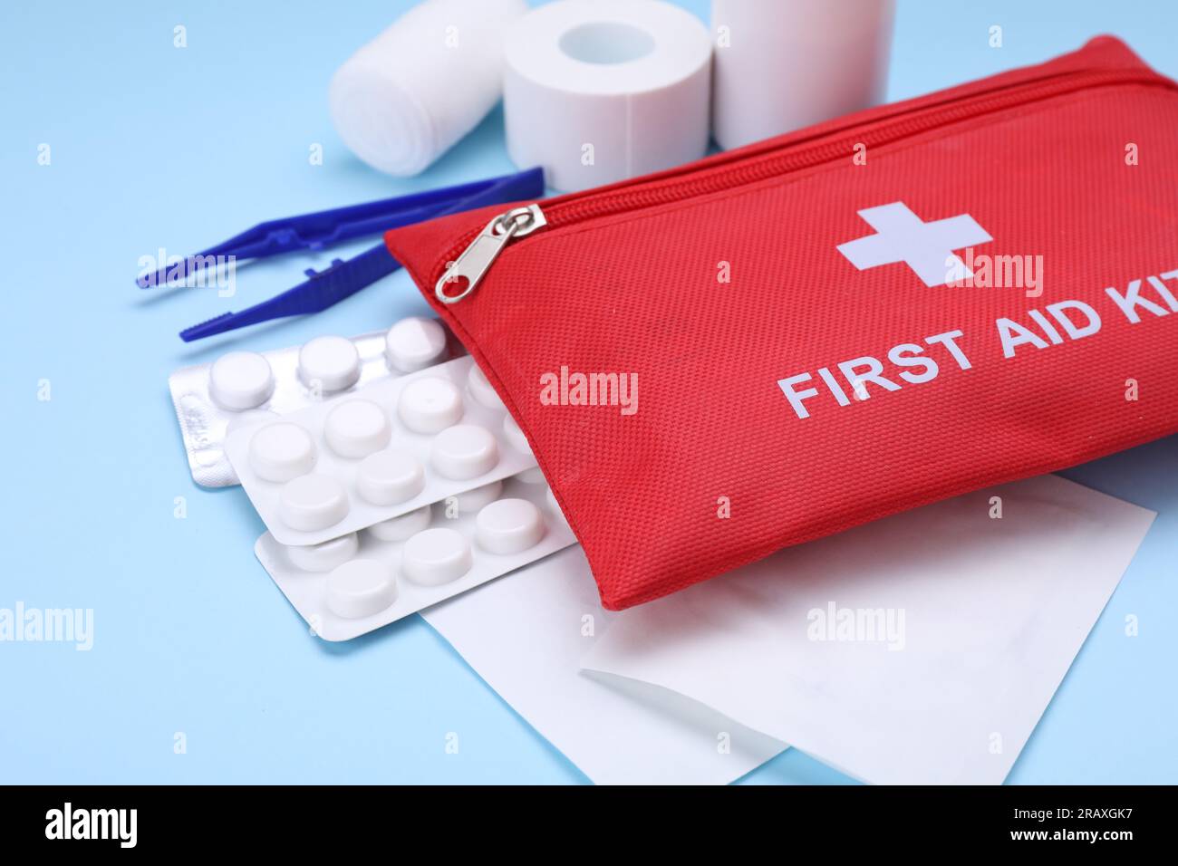 First aid kit on light blue background, closeup Stock Photo - Alamy