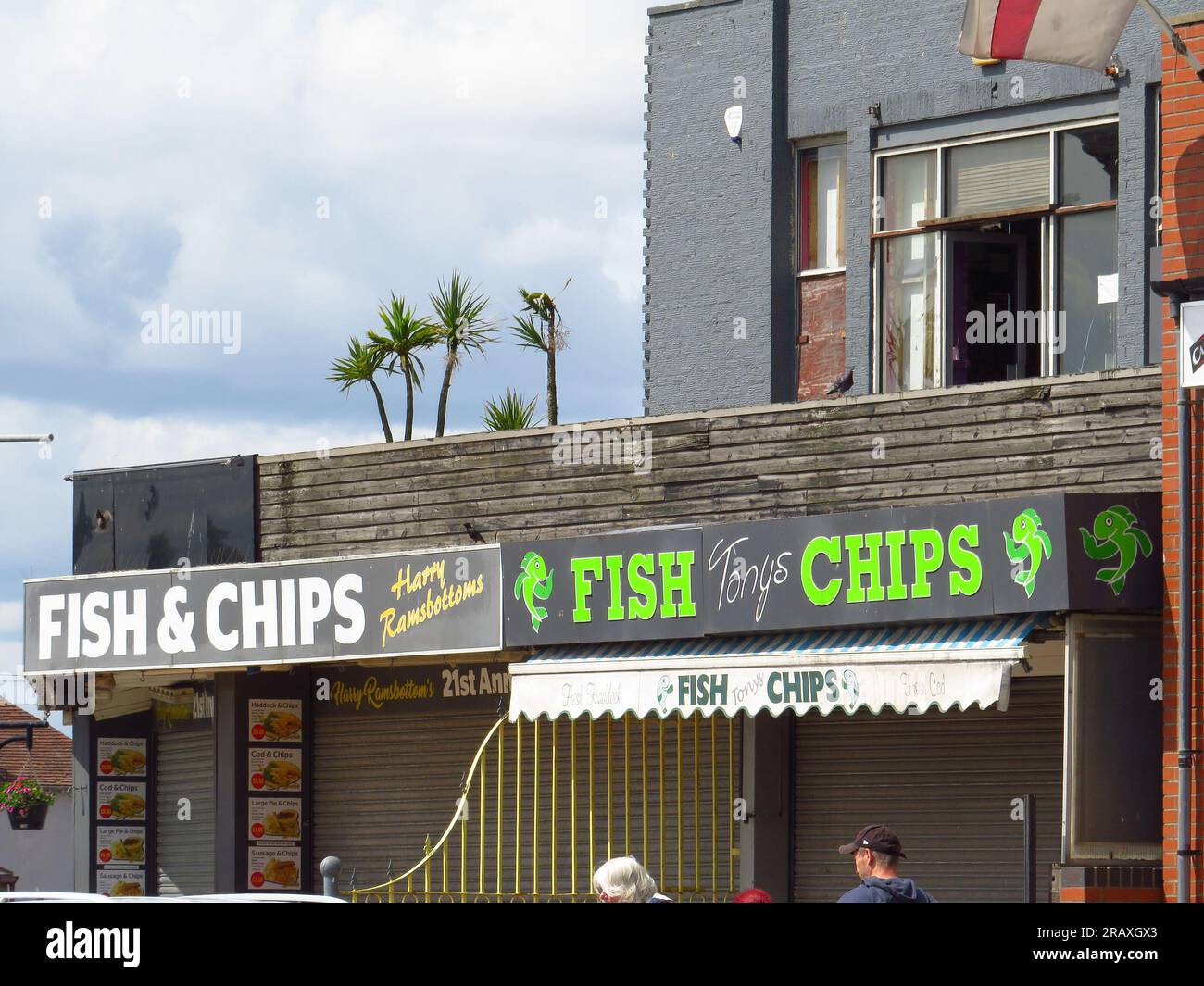 Fish & chip shop signs on the seafront in Skegness Stock Photo - Alamy