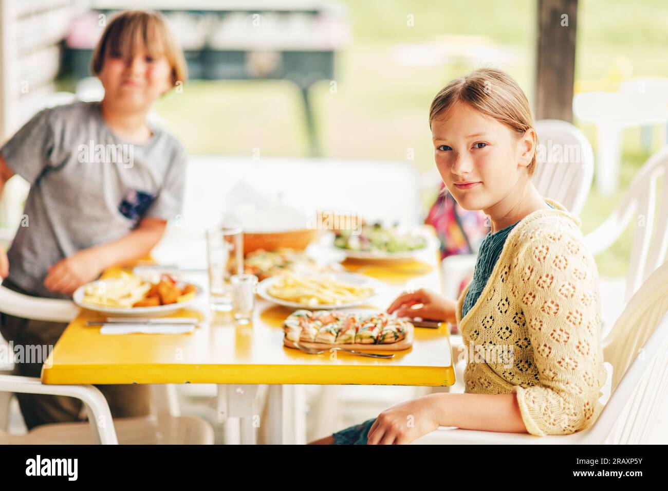 Family having lunch outside on a terrace, background with meal Stock Photo