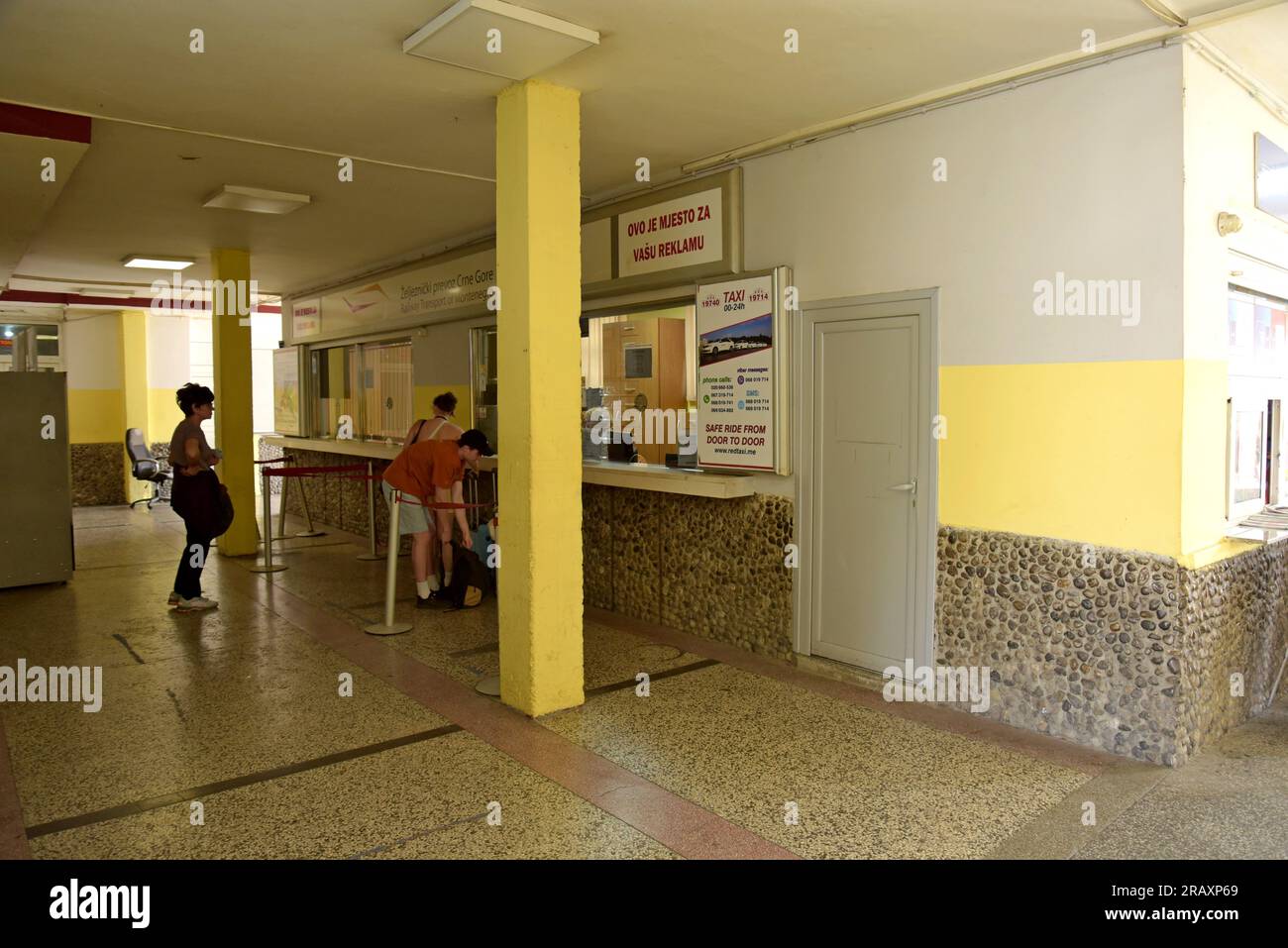 People queuing at the ticket office in the main railwat station, Podgorica, Montenegro Stock Photo
