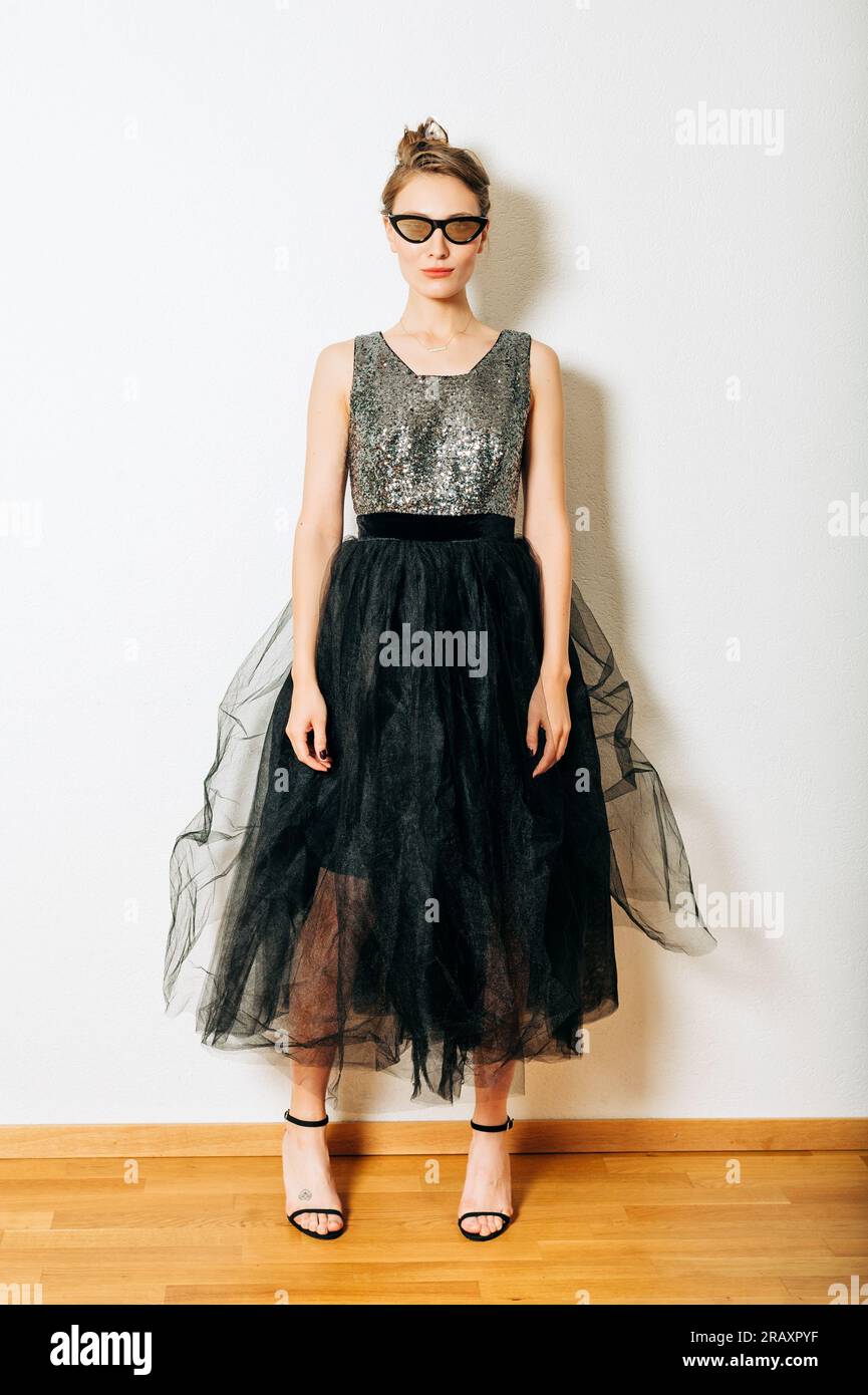 Woman wearing long black dress hi-res stock photography and images - Alamy