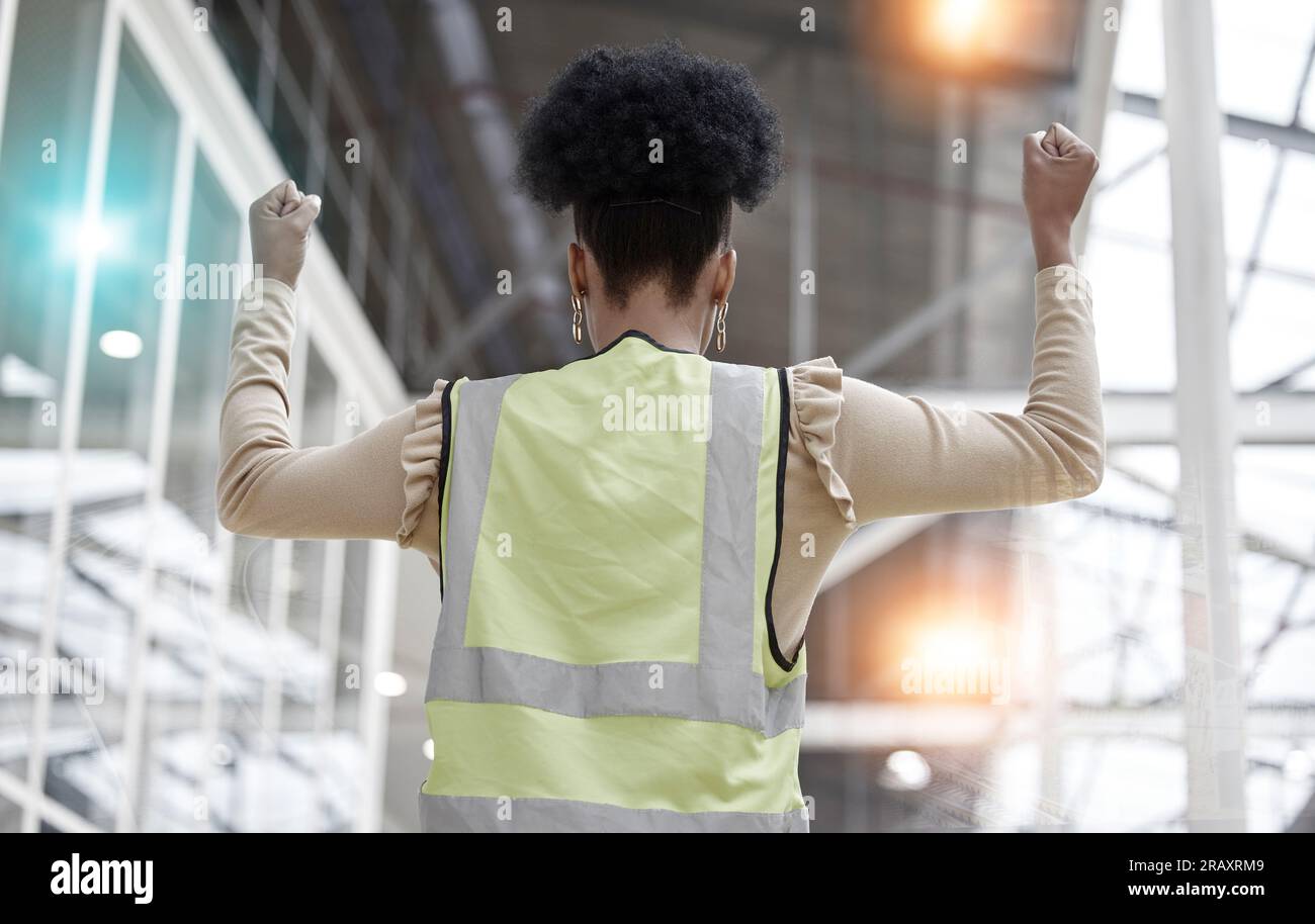 Woman, success or architect in celebration of deal for industrial property or real estate with hands up. Back view, winner or happy designer with Stock Photo