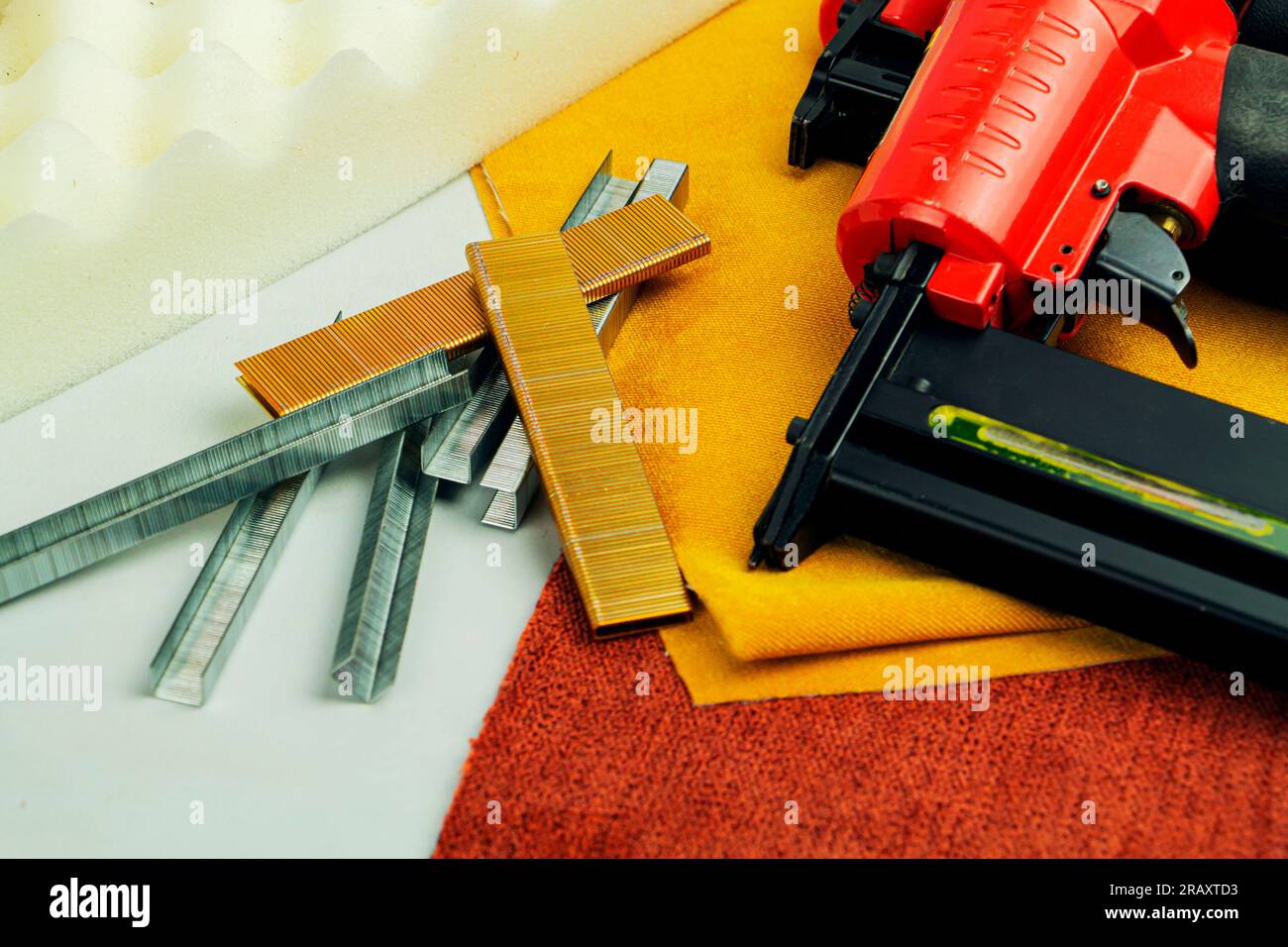 concept of furniture production and repair. Stapler and staples, working tool. Stock Photo