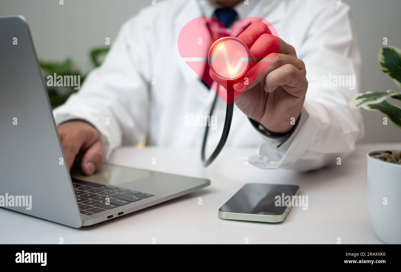 A Doctor holding and showing a red heart at hospital office. Medical ...