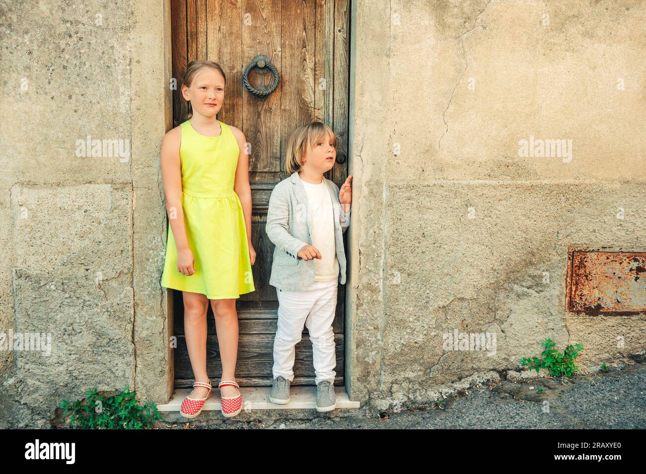 Fashion portrait of adorable little boy and girl posing outdoors Stock ...