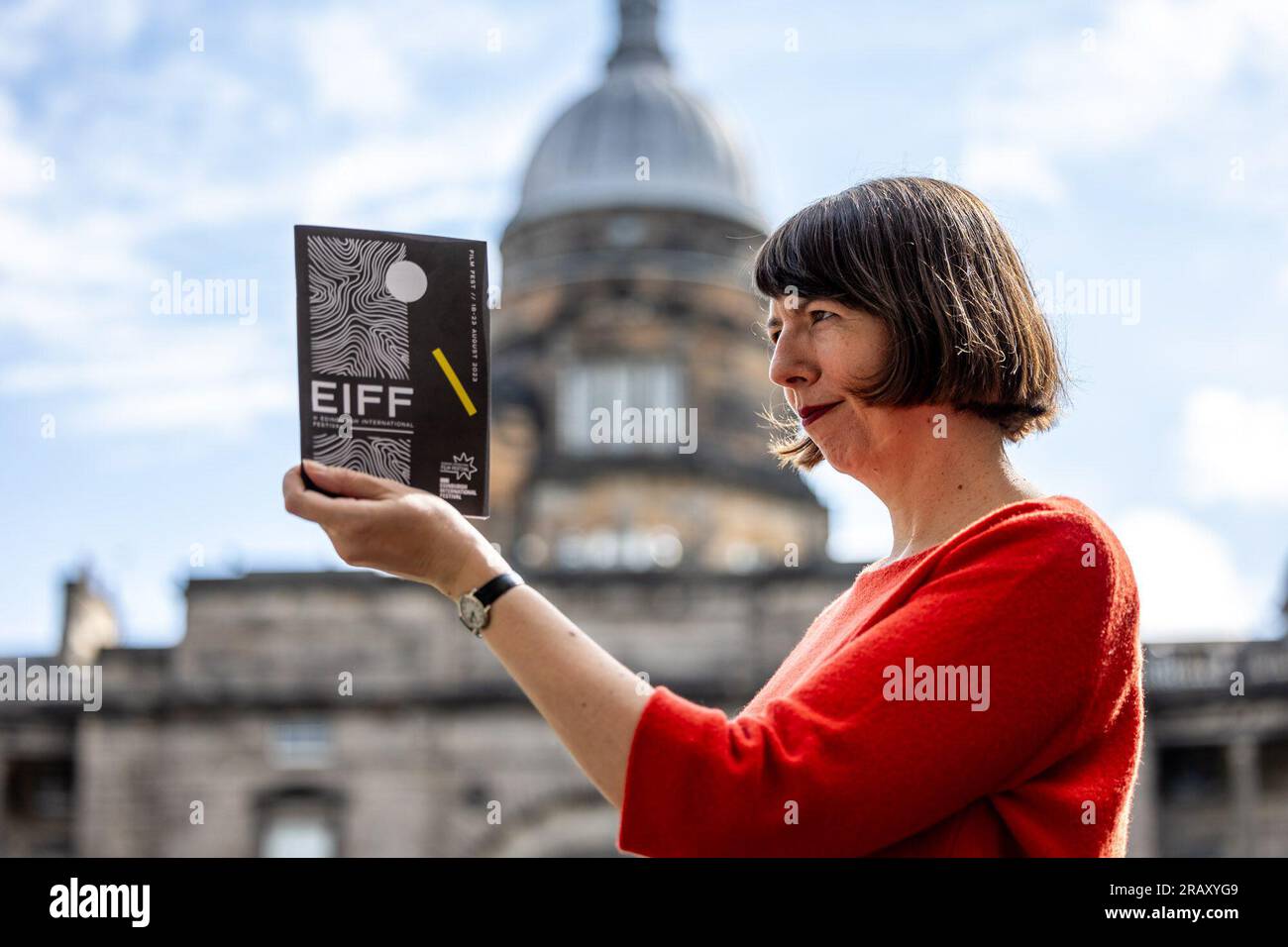 Edinburgh, United Kingdom. 06 July, 2023 Pictured: Kate Taylor, Festival Director with the Film Festival programme. Edinburgh International Film Festival, which this year is hosted by Edinburgh International Festival, returns for a six-day celebration of bold and eclectic cinema at the heart of the world’s biggest celebration of arts. Festival director Kate Taylor is joined by members of this year’s programming team to show off their new festival brochure, set against the picturesque background of Edinburgh University’s Old College Quad. Credit: Rich Dyson/Alamy Live News Stock Photo