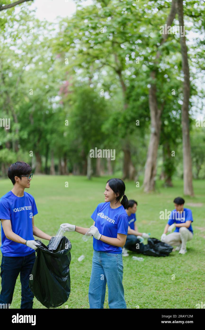 Multiethnic volunteers donate their time holding black garbage bags to