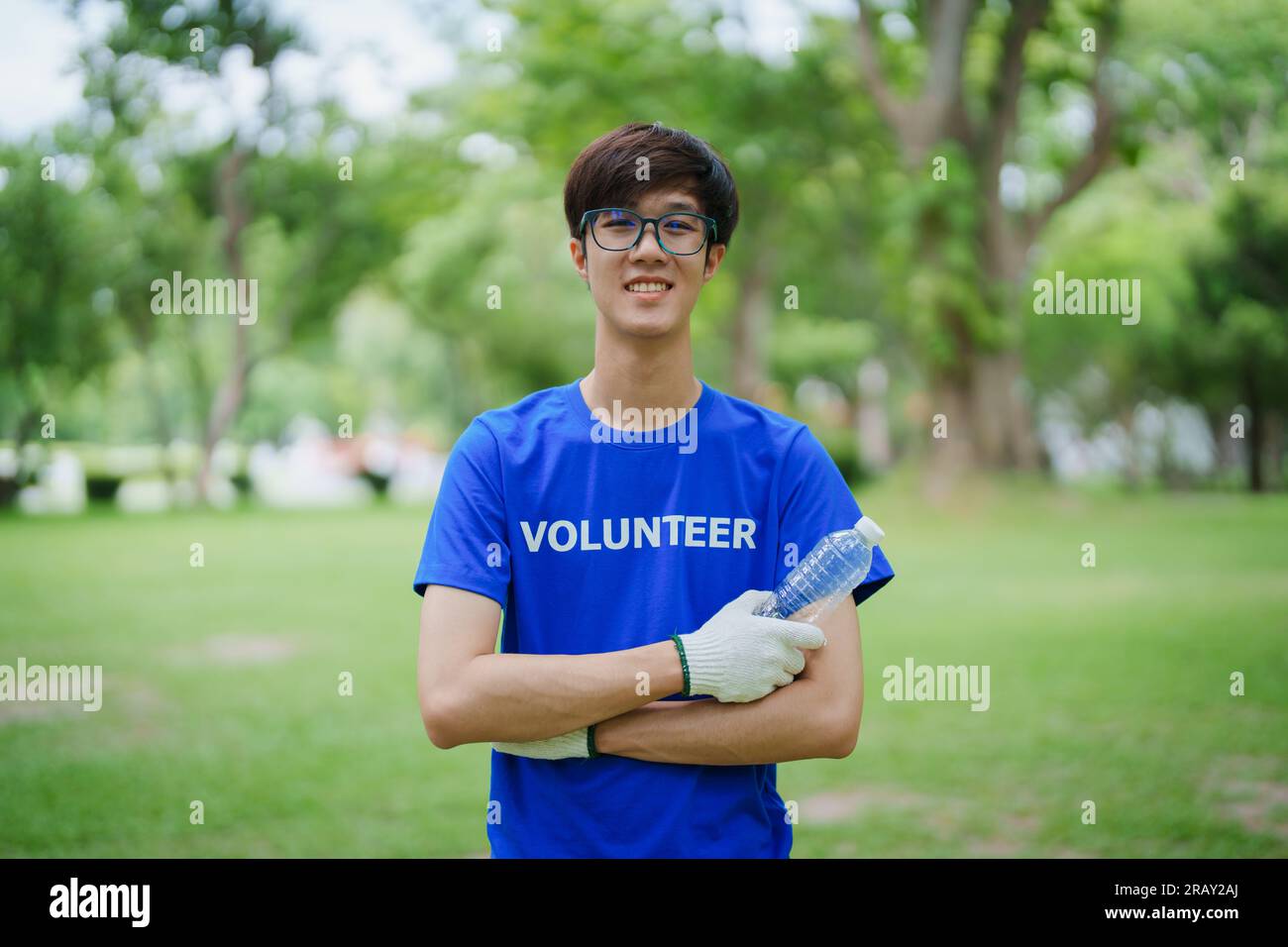 Multiethnic volunteers donate their time holding black garbage bags to
