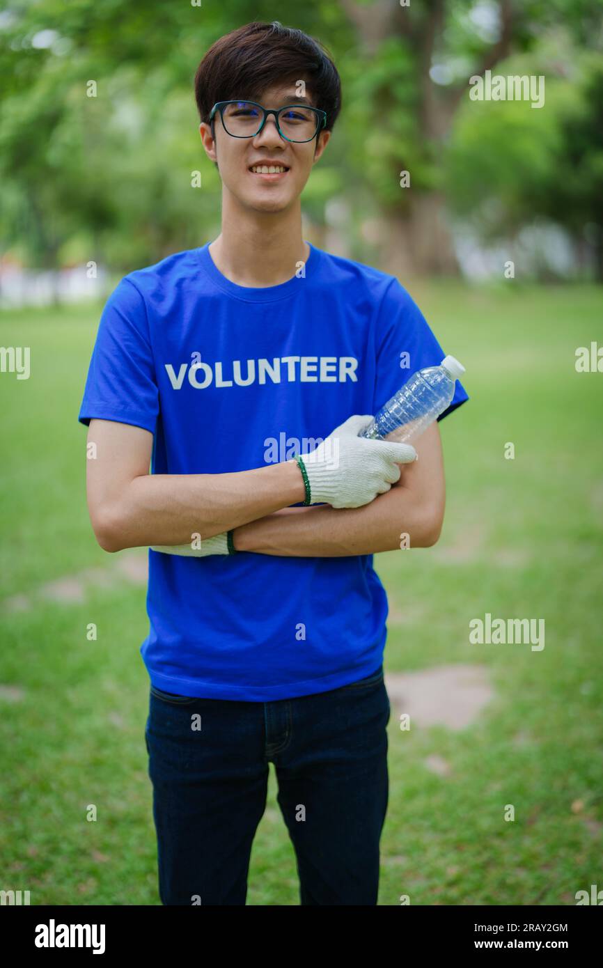 Multiethnic volunteers donate their time holding black garbage bags to