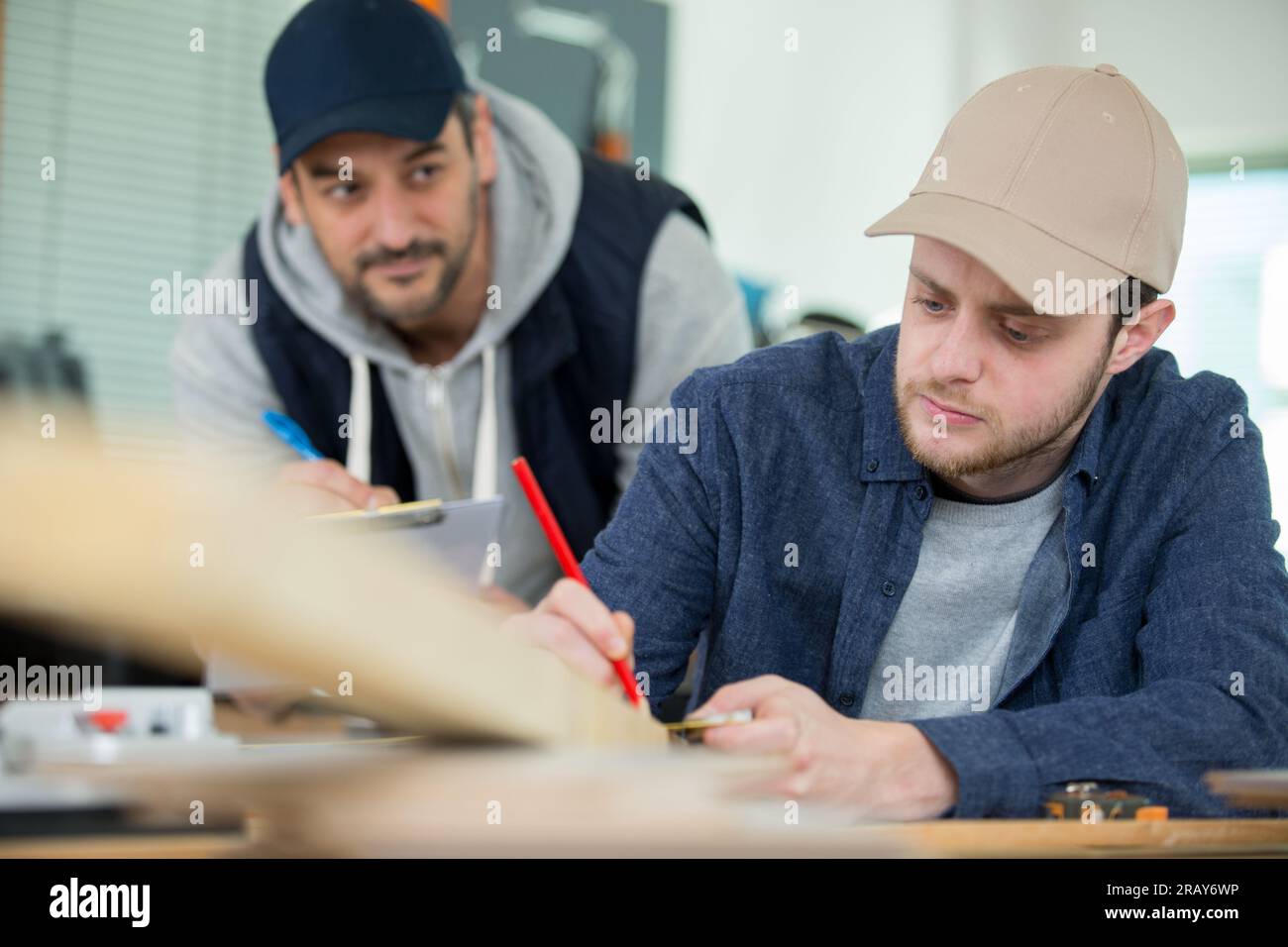 carpenter with apprentice in training period Stock Photo