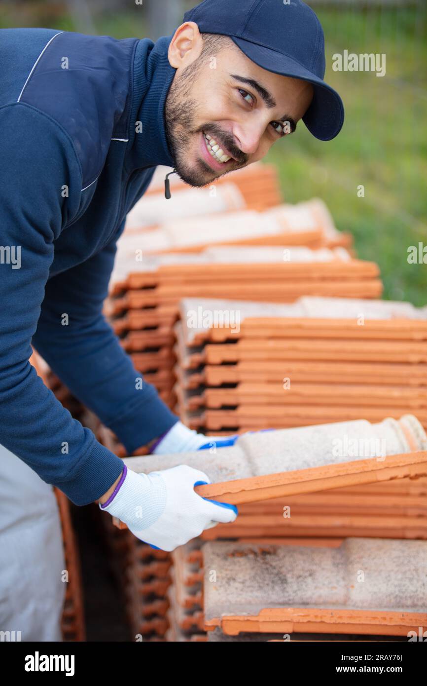 bricklayer industrial worker installing brick masonry Stock Photo