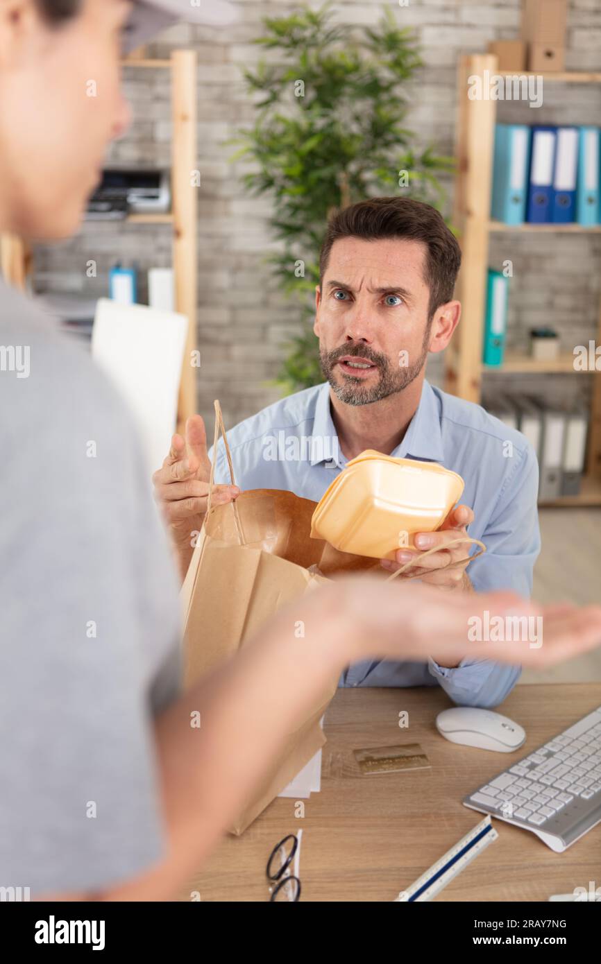 delivery man delivering lunch box or lunch box in office Stock Photo