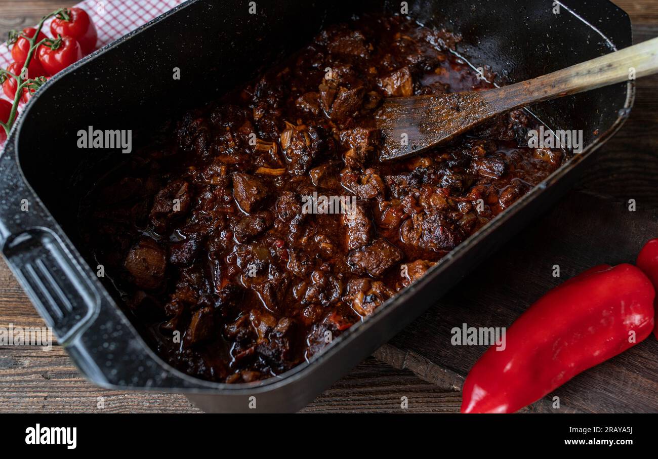 Oven braised pork in a roasting pot Stock Photo