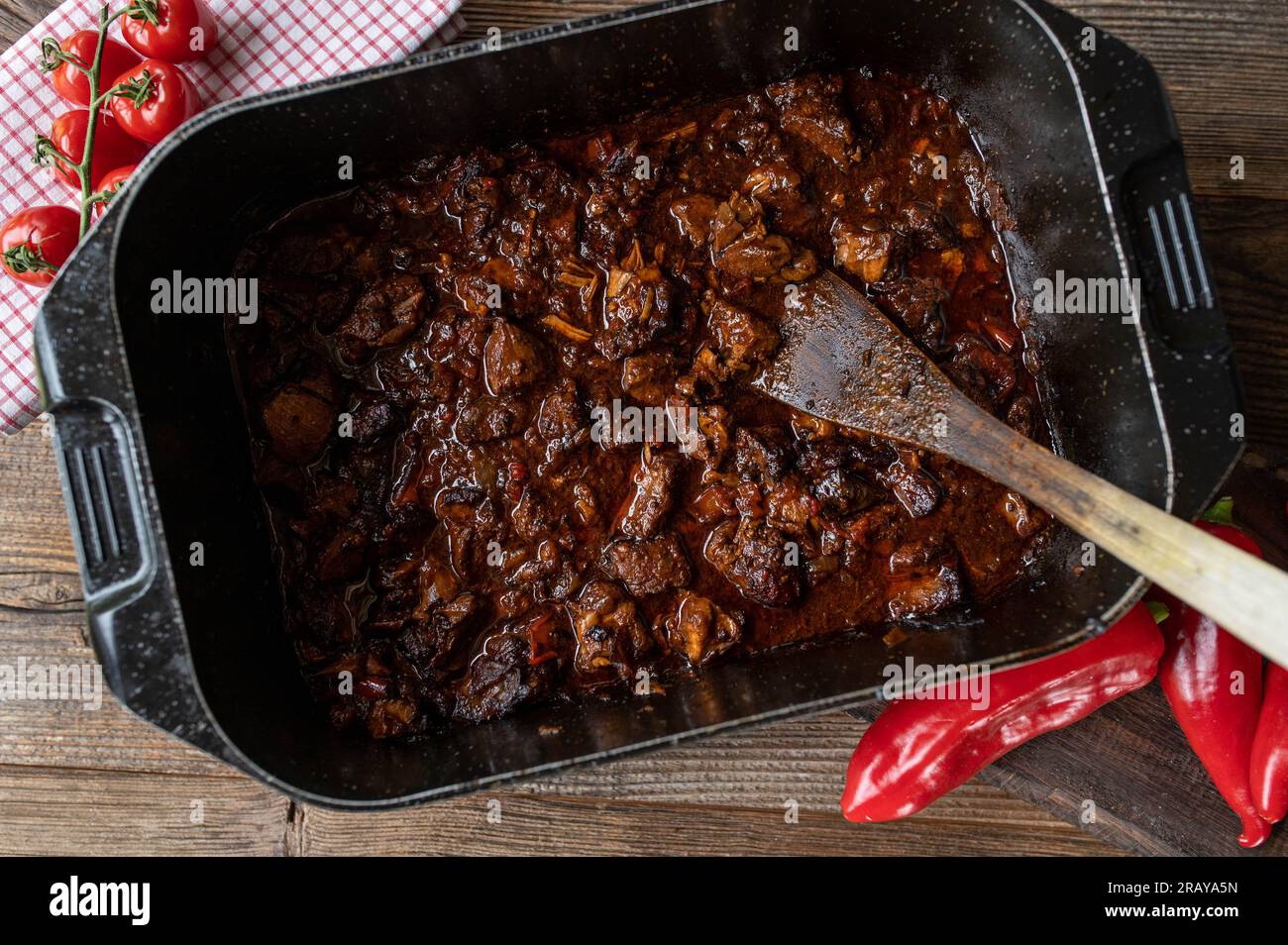 Oven braised pork in a roasting pot Stock Photo