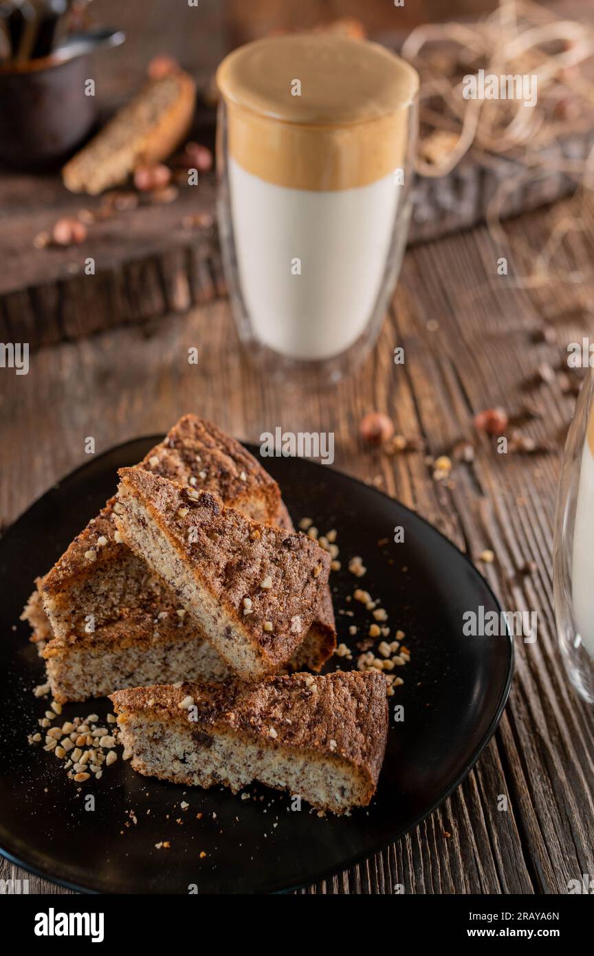 Nut cake with dalgona coffee on wooden table Stock Photo