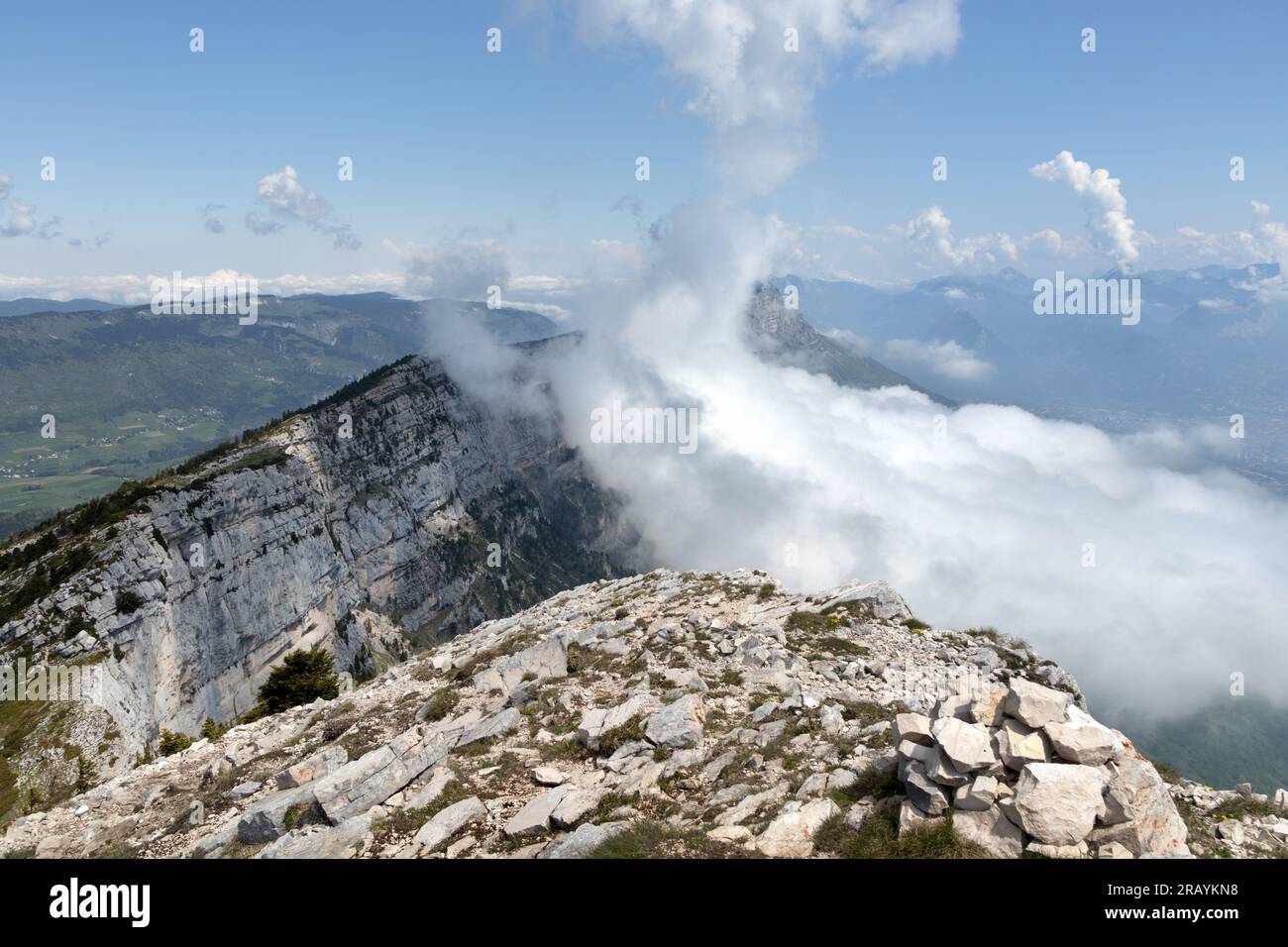 The view north from the summit of the Pic Saint Michel (alt 1,966m) as cloud envelops the mountain of Moucherotte beyond, Vercors Massif, Lans en Verc Stock Photo