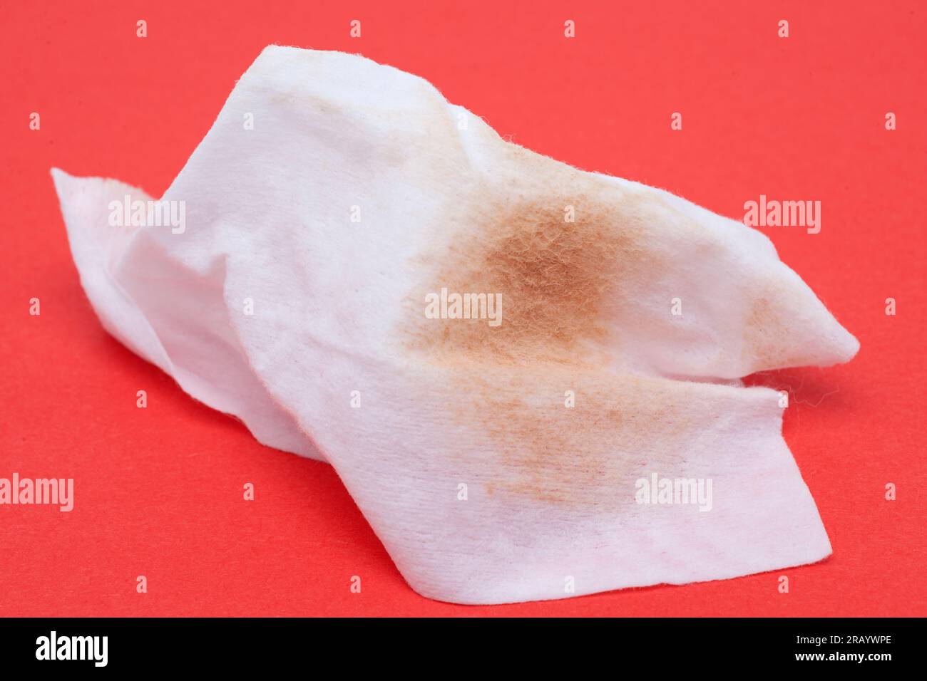 Used Wet Wipe Makeup Remover on a Red Background Stock Photo