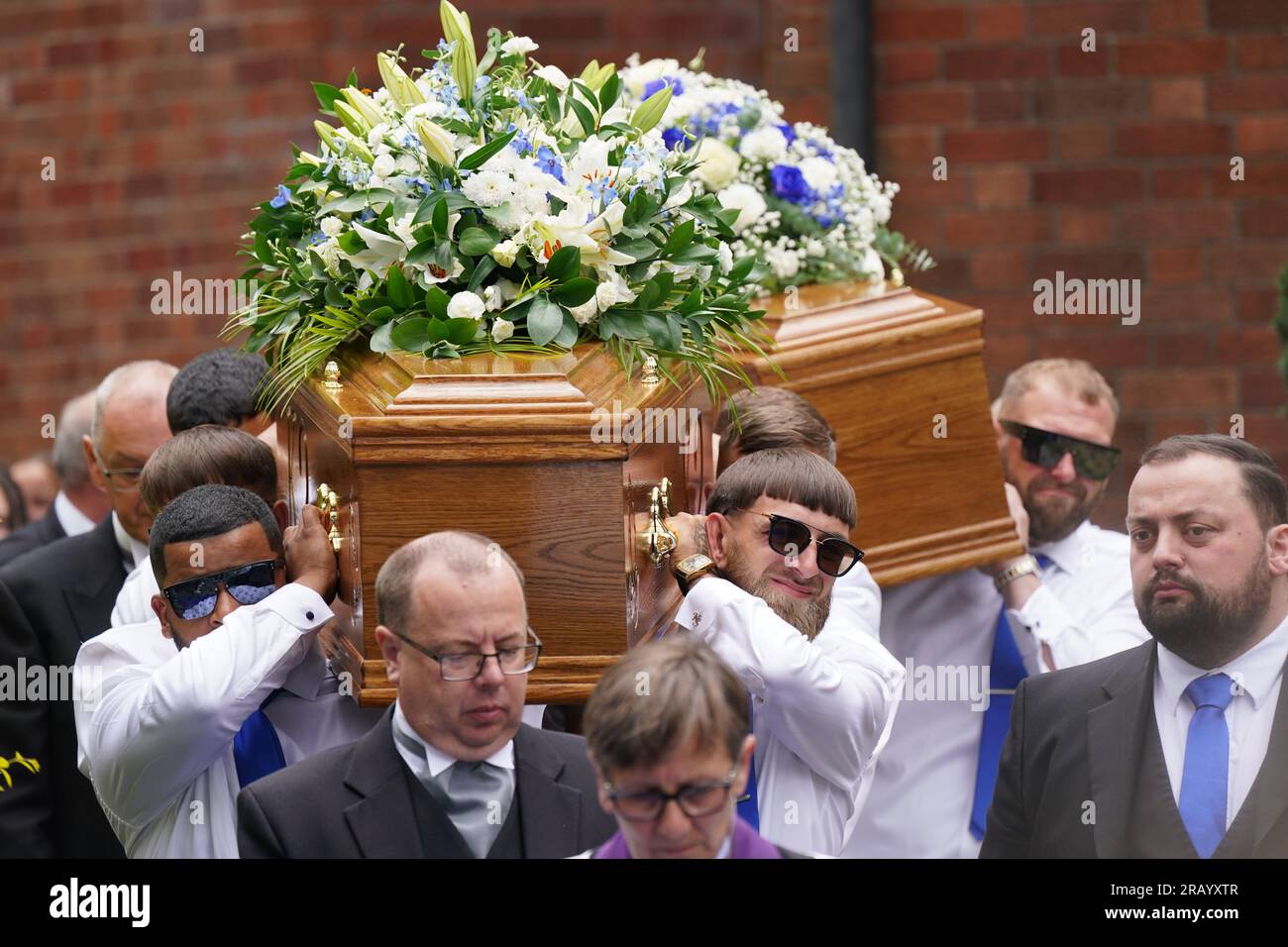 The coffins of Kyrees Sullivan and Harvey Evans are carried out of the ...
