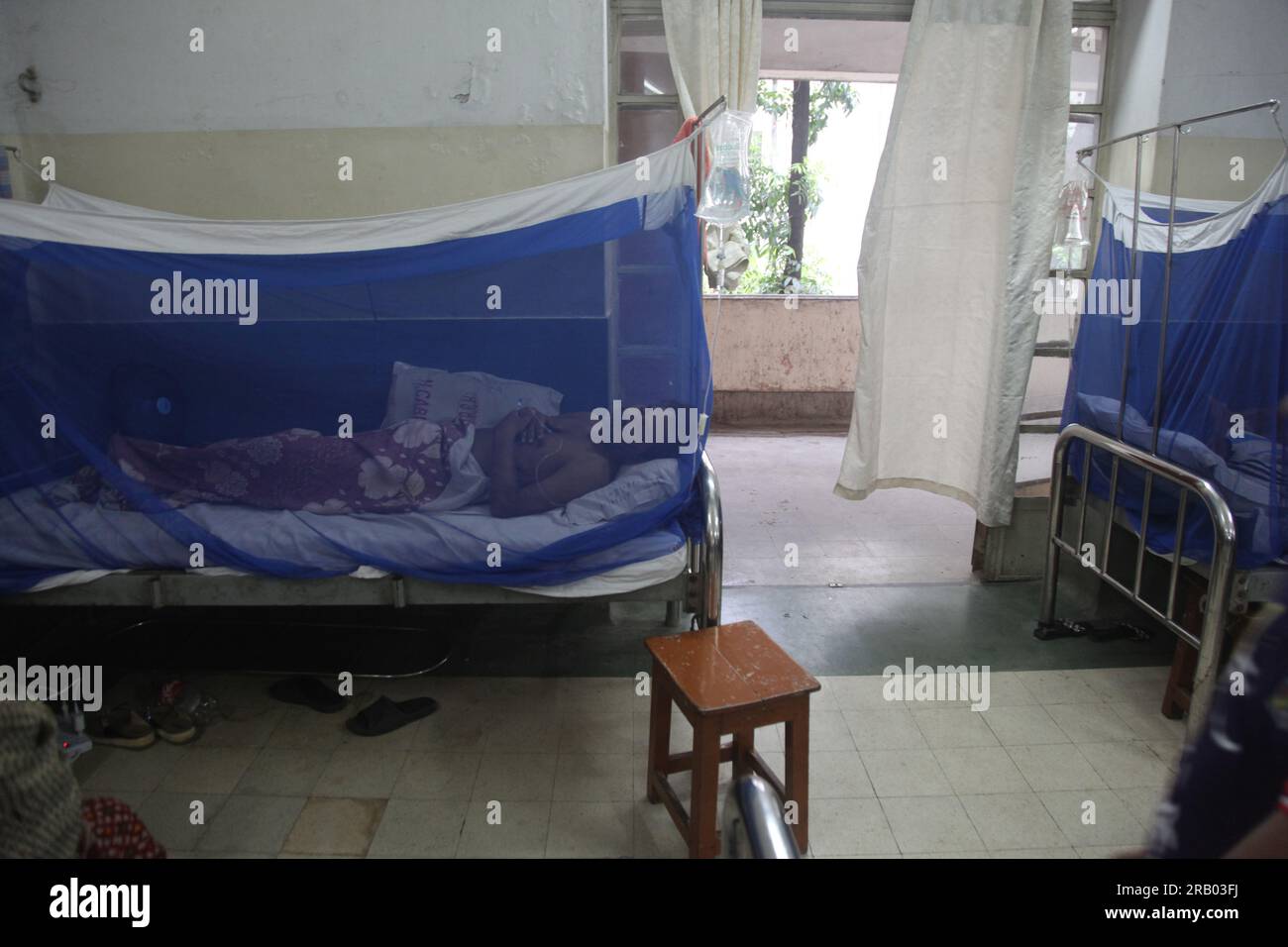 Dhaka Bangladesh 6july 2023.Bangladeshi dengue patients covered with a mosquito net suffers from dengue fever as they receive treatment inside Holy Fa Stock Photo