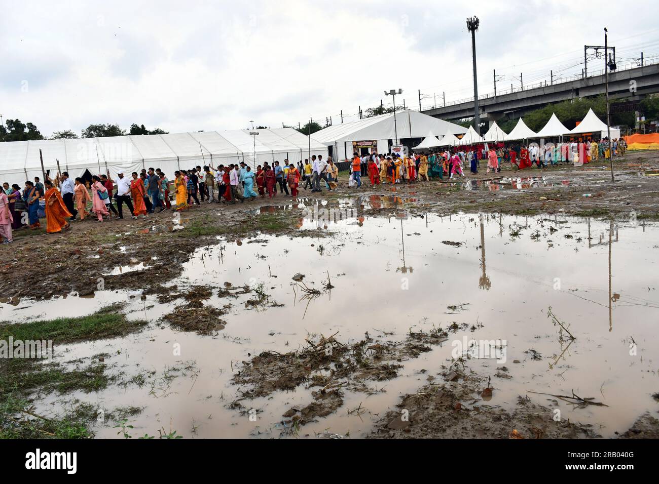 East Delhi, Delhi, India. 6th July, 2023. Devotees Reached in muddy for the Lord Hanuman devotee Pandit Dhirendra Shastri blessing and being Greeted by Devotees during arrival for Three Day Katha Vachan.Pandit Dhirendra Krishna Shastri of Bageshwar Dham at Ramlila Maidan, IP Extension, Delhi. Divine Darbar, Kalash Yatra and Havan are also being organized in this. According to the local people, people from all the surrounding areas including Delhi are reaching here.Pandit Pandit Dhirendra Krishna Shastri will be present at the Divya Darbar at the venue of the event. Big screens are being inst Stock Photo