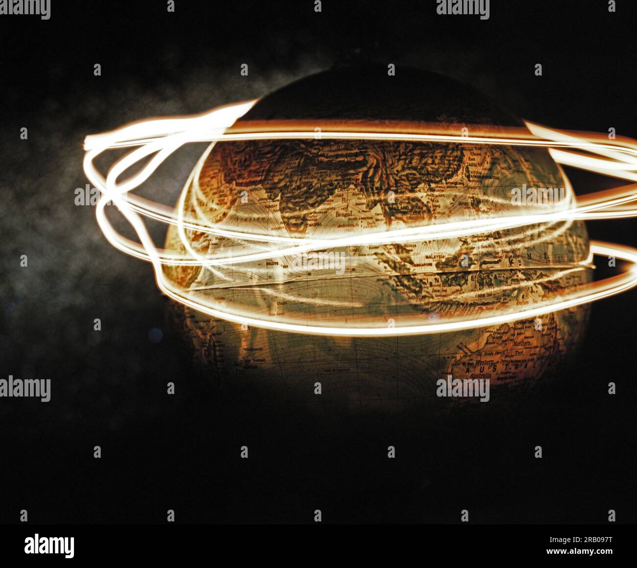 Light streaks encircling globe Stock Photo - Ala…
