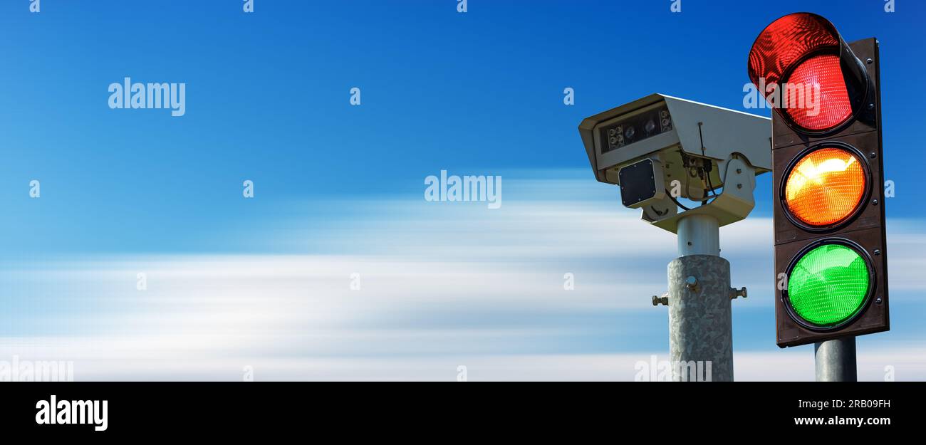 Closeup of a traffic light and a traffic control camera against a clear blue sky in motion with copy space. Stock Photo