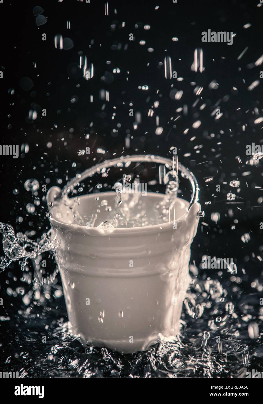 Bucket of water with heavy rainfall splash Stock Photo Alamy