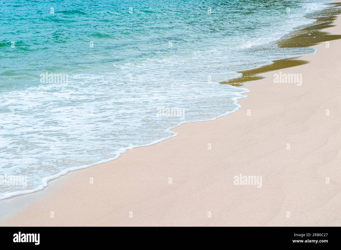 Soft beautiful ocean wave on sandy beach. Background. Copy space. Stock Photo