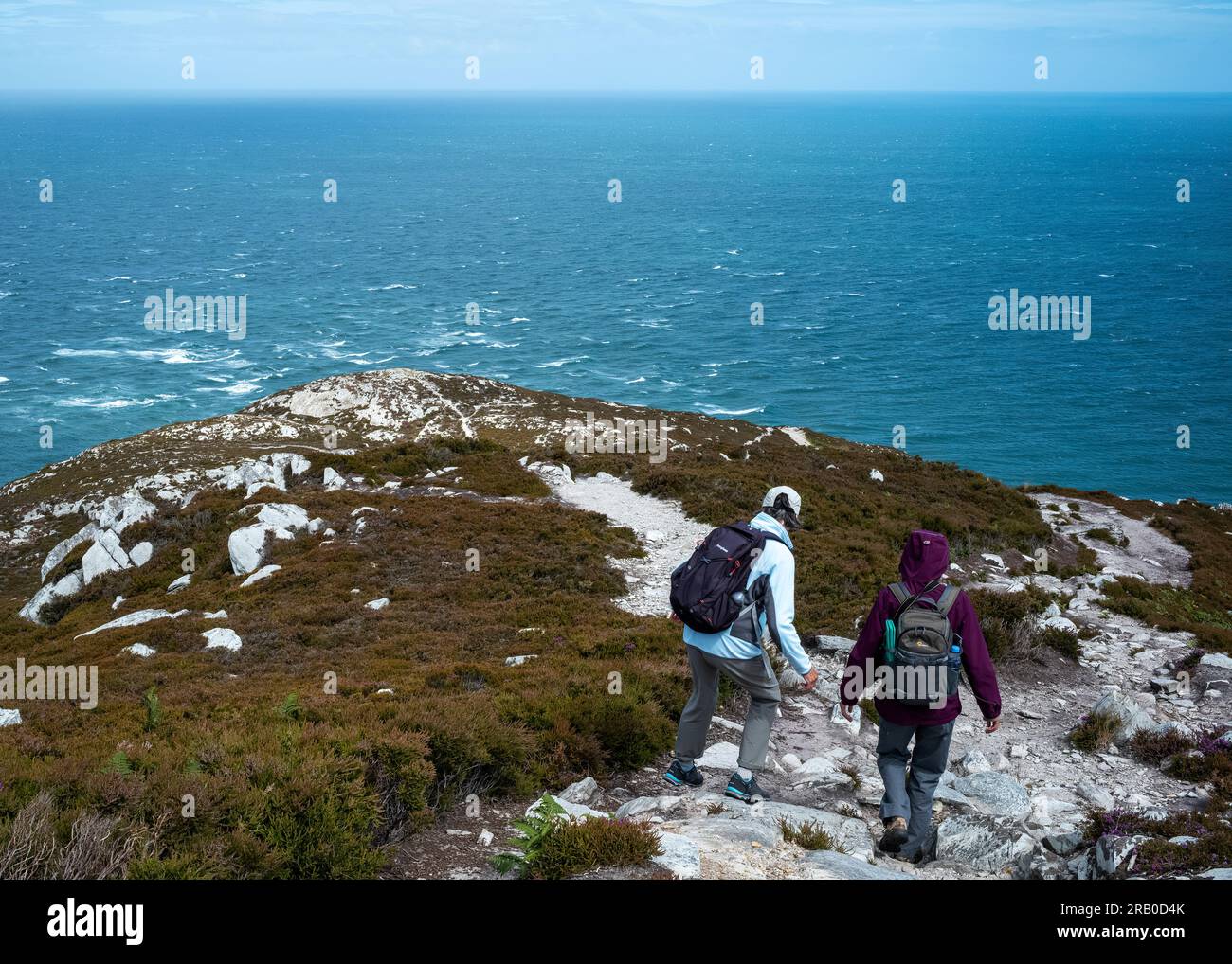 'One foot at a time' descending Holyhead Mountain, Holy Island, Anglesey, Wales, UK Stock Photo