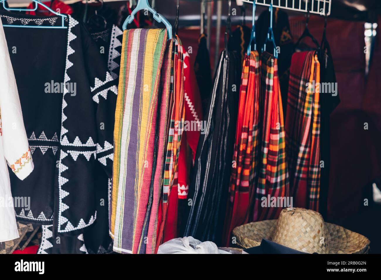 Array of traditional handwoven T'boli Malongs (tube skirts) and dresses of T'boli women called 'Kegal T'boli' Stock Photo