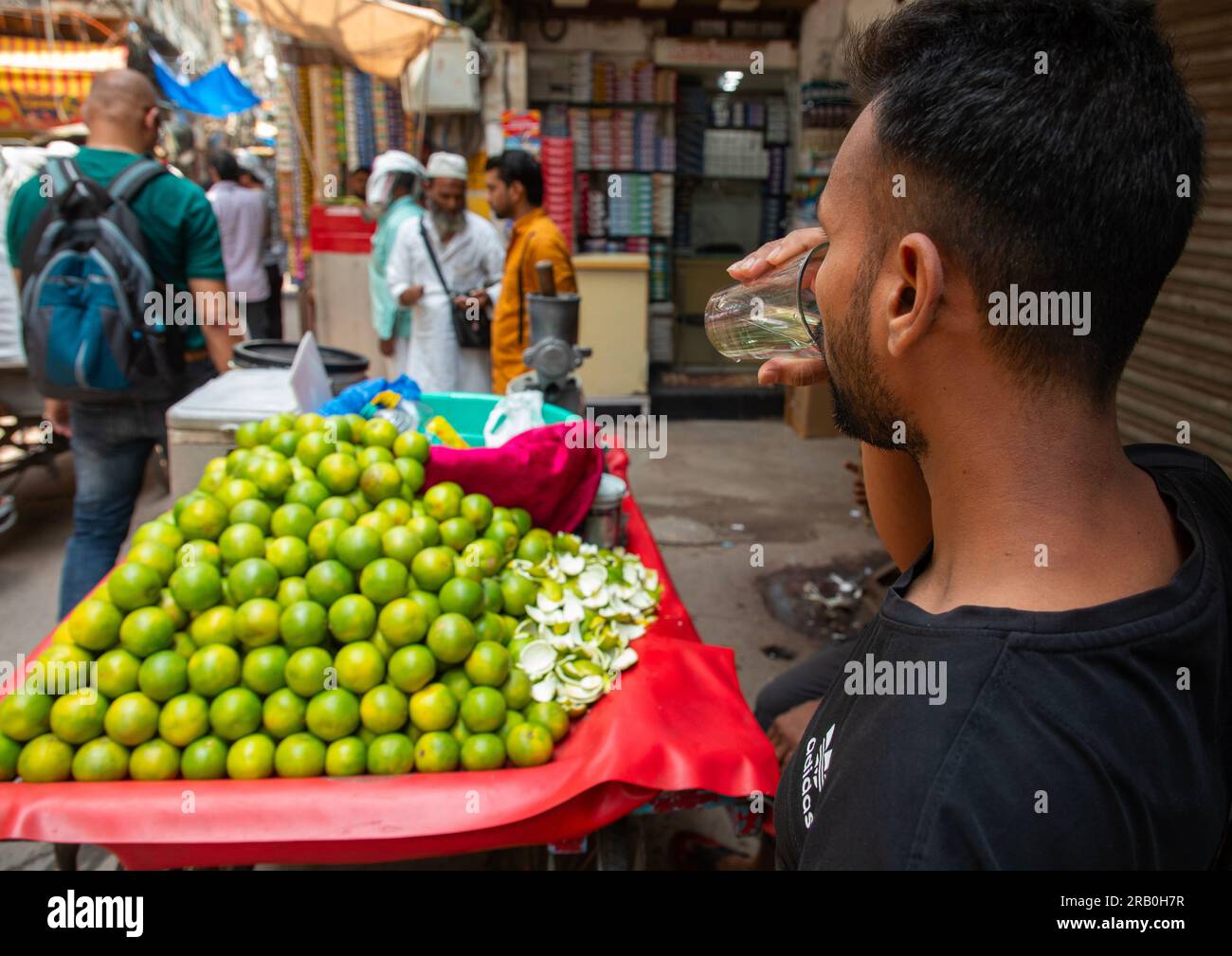 Indian man drinking orange juice in old Delhi, Delhi, New Delhi, India Stock Photo