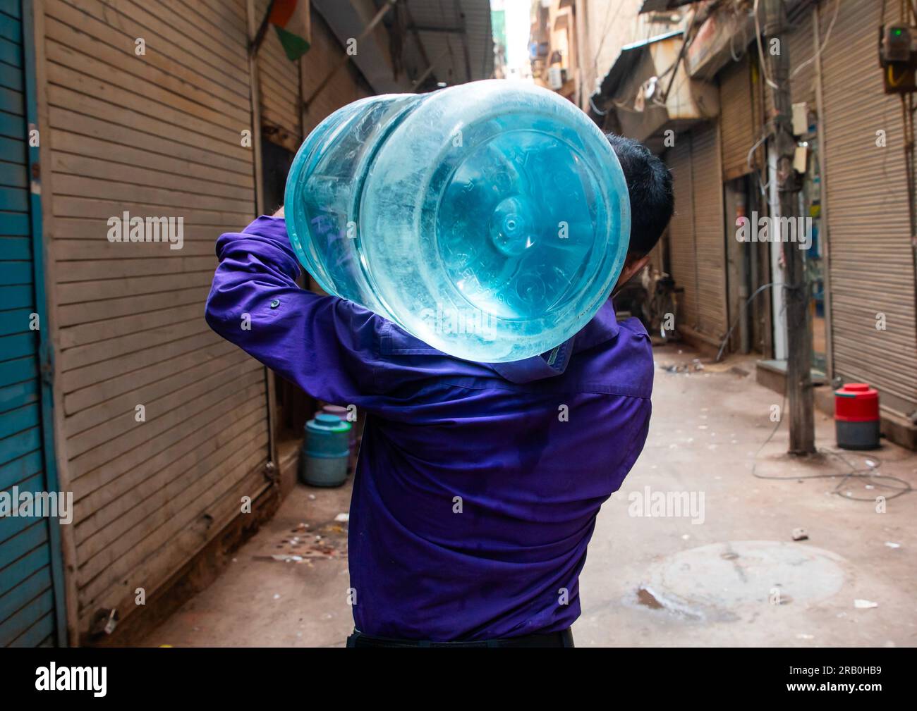 Man carrying plastic bottled water in old Delhi, Delhi, New Delhi, India Stock Photo