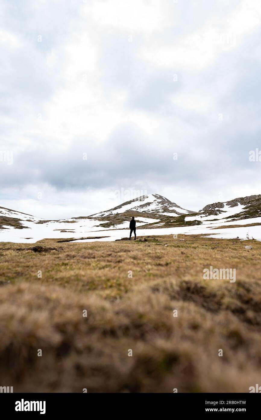 Stunning view of a person who is trekking on a snowy mountain. Monte Cotento, Campo Staffi, Frosinone, Italy. Stock Photo