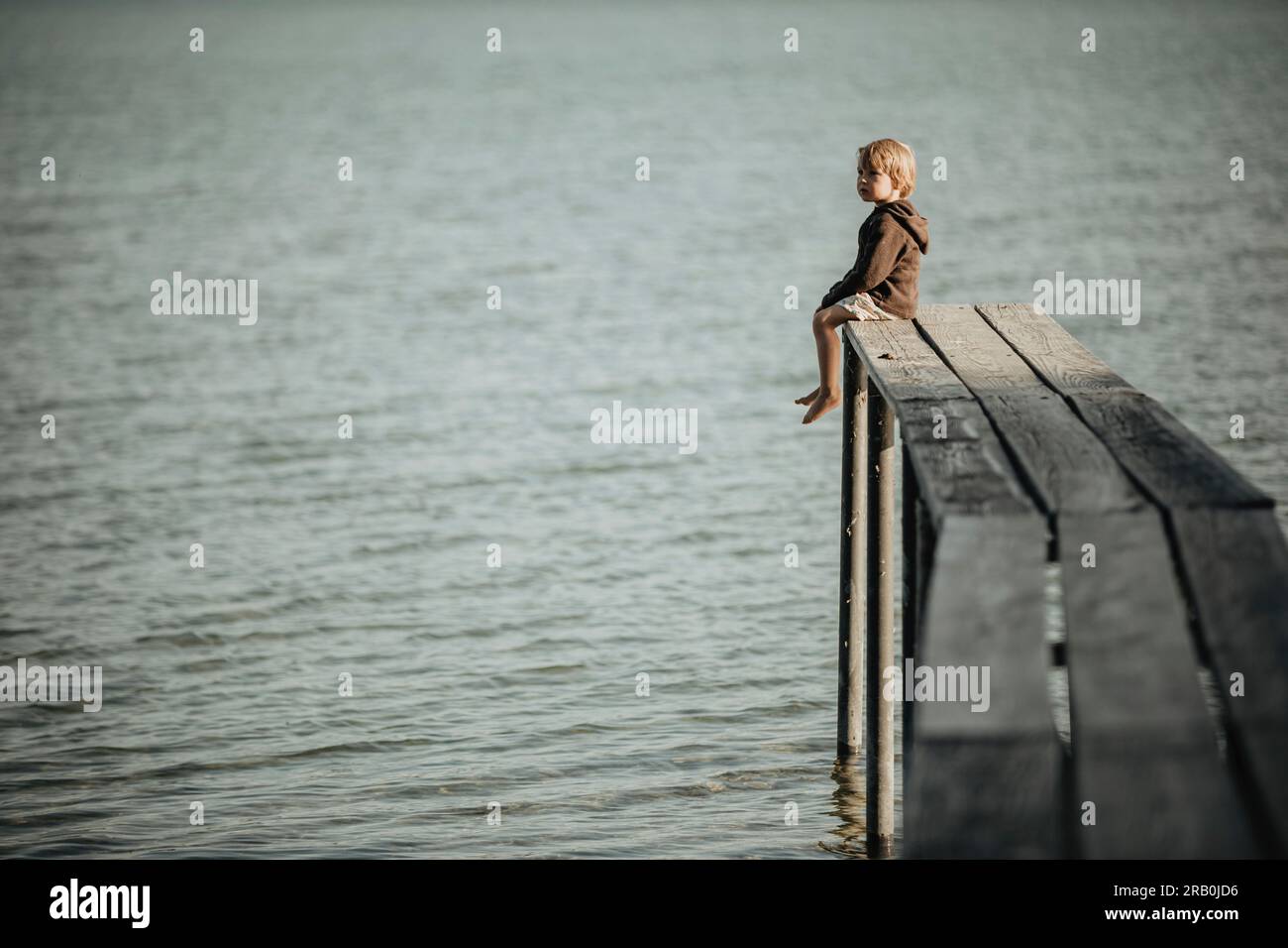 Teen sitting on dock hi-res stock photography and images - Alamy