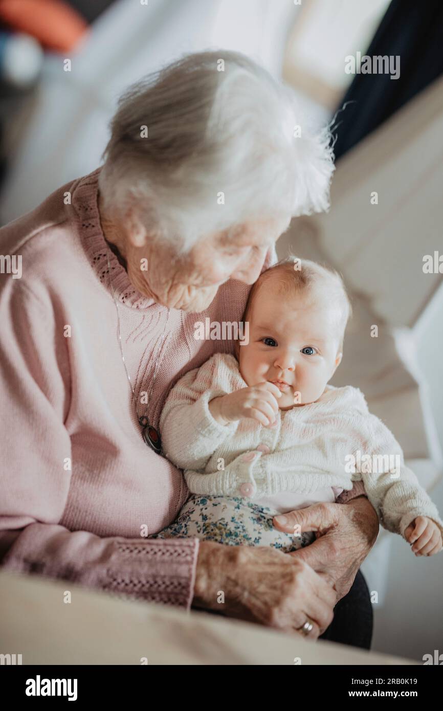 Great grandmother holds her great granddaughter in her arms Stock Photo