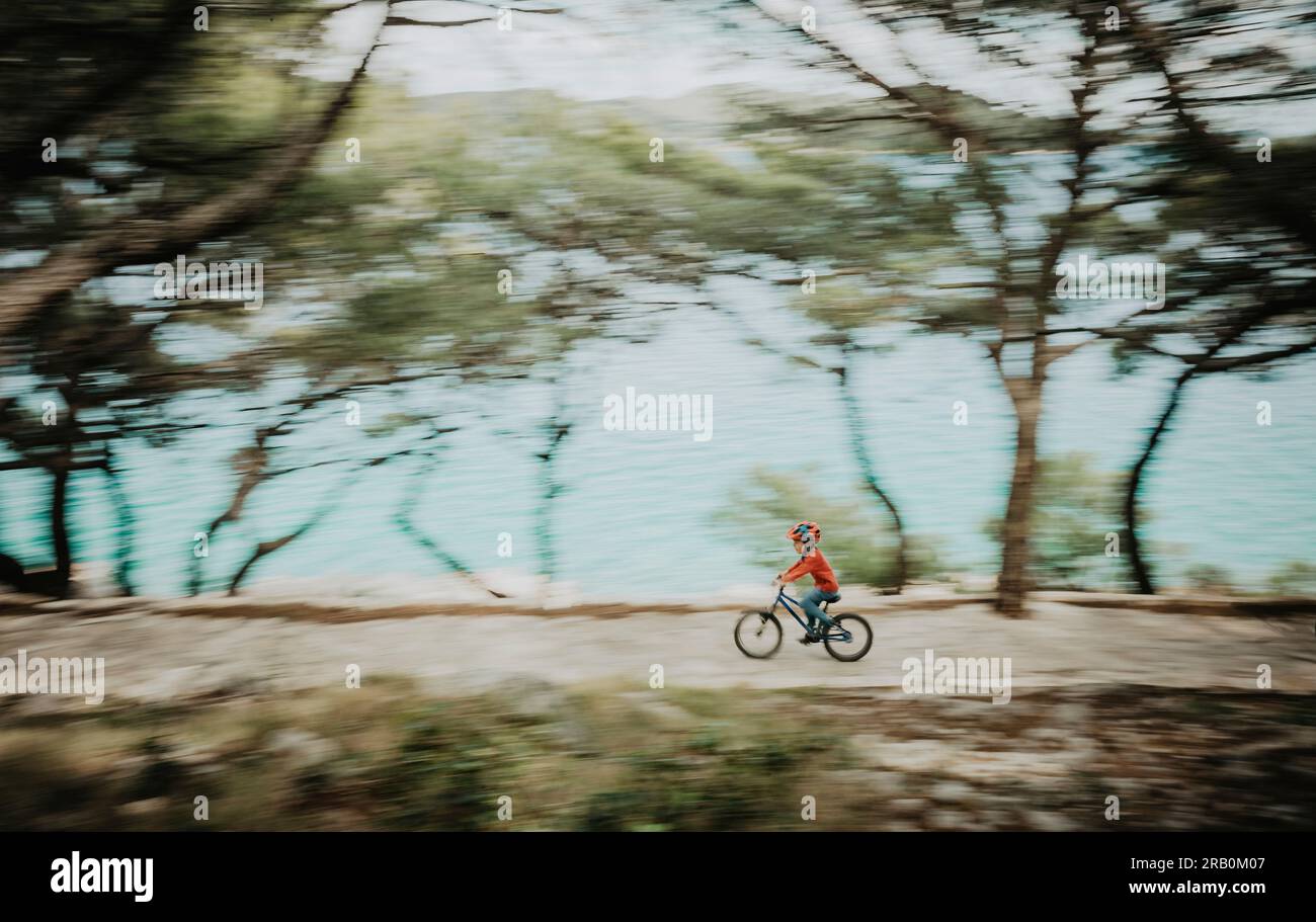 Boy riding bicycle on boardwalk Stock Photo