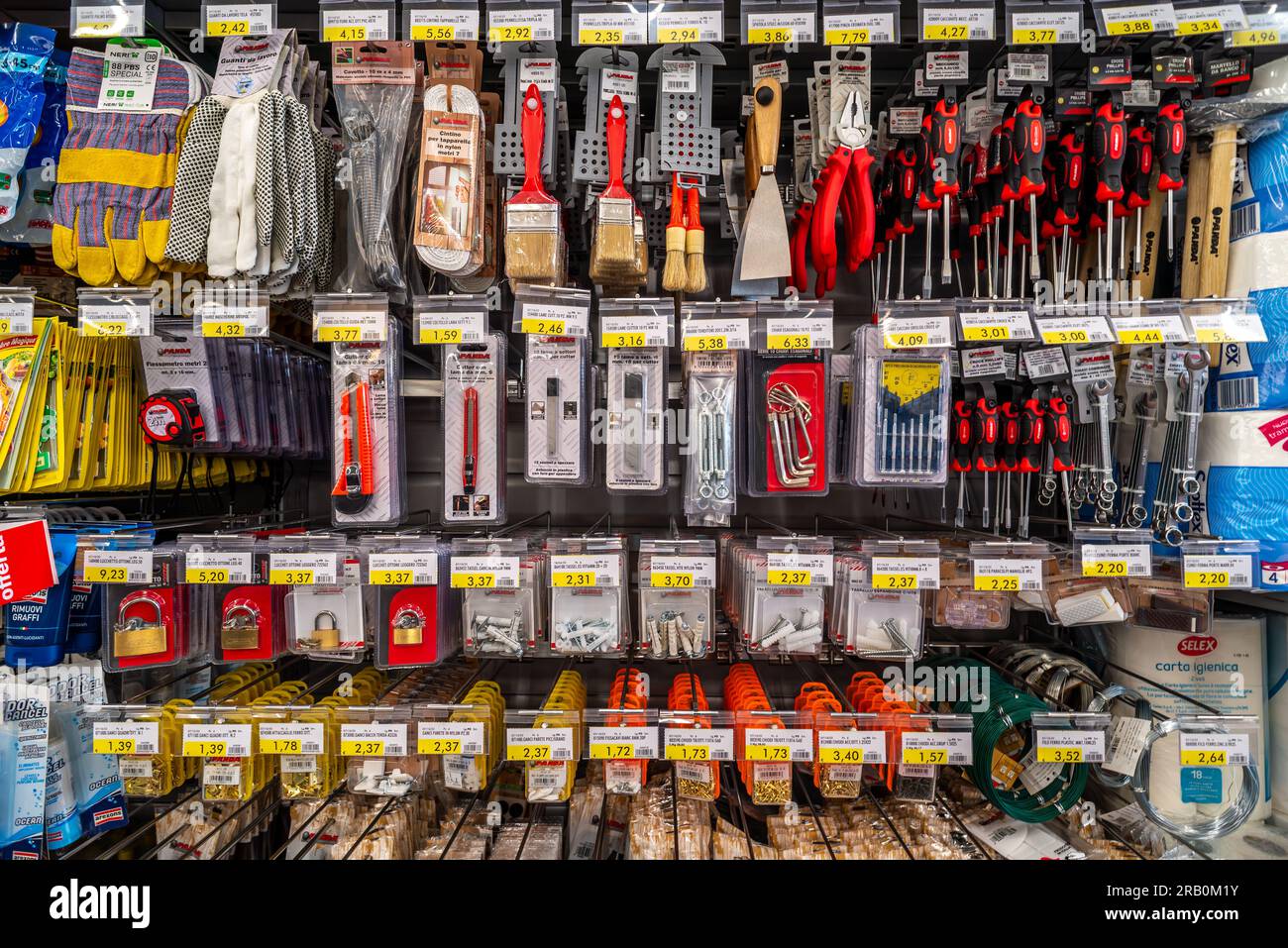 Italy - July 06, 2023: Various repair tools for sale on shelves hardware store in supermercato italiano. Stock Photo