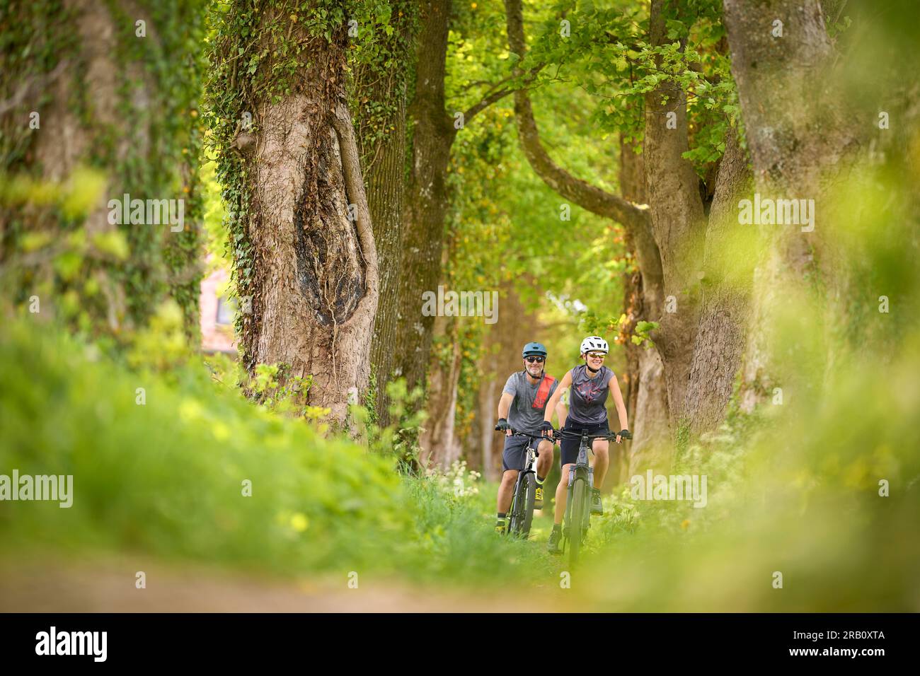 Couple, man and woman touring with bicycles, trekking bike and e-bike Stock Photo