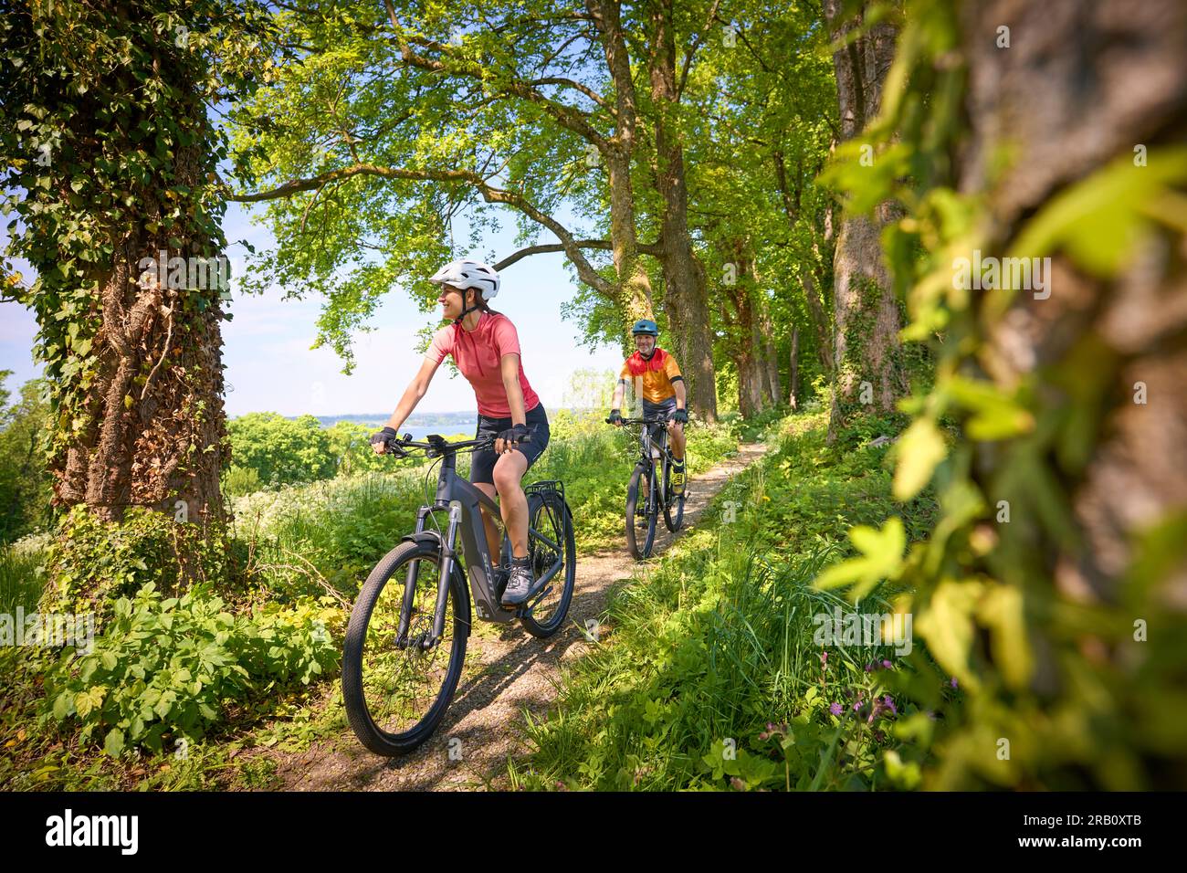 Couple, man and woman touring with bicycles, trekking bike and e-bike Stock Photo