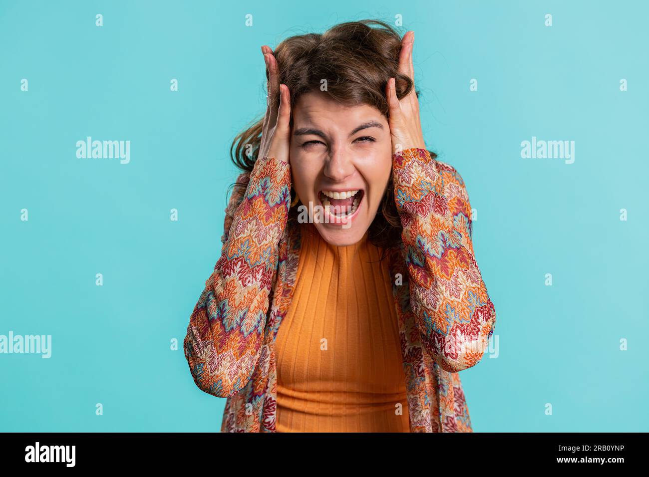 Caucasian woman scared fearful, covering ears with hands, closing eyes