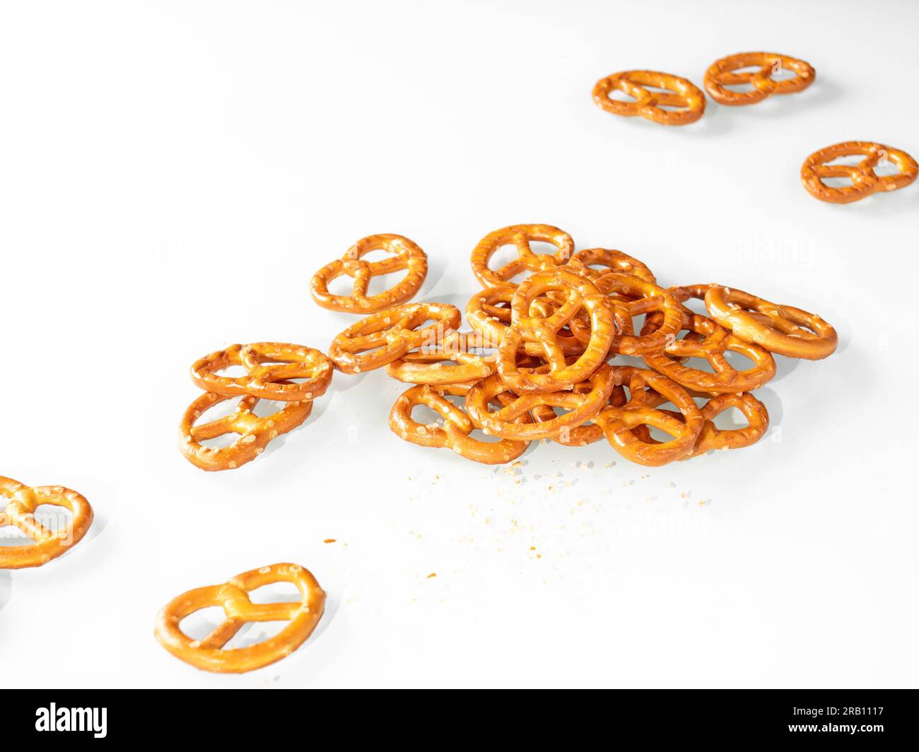 Stack of cumin pretzels on white background. Stock Photo